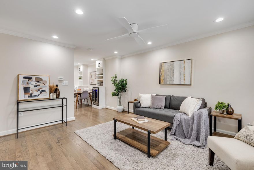 Fully renovated 2-bedroom, 2-bathroom Clarendon I townhome nestled in Fairlington Mews! The main level includes a bright living room with refinished hardwood flooring, recessed lighting, a modern ceiling fan, wood shutters, & crown molding. Custom built-in shelving & cabinetry connect the living room to the open kitchen, which offers updated white cabinetry, a tile backsplash, new stainless steel appliances (2024), a custom wood range hood, stainless farmhouse sink, pantry cabinets with pull-out shelving, and a large island with quartz waterfall countertops, blue cabinetry, pendant lighting, & stool seating. The dining area features a built-in bench with storage and custom shelving with a wine rack, wine cooler, & cabinets. And finally, a back door opens to the large paver patio - ideal for entertaining or relaxing outdoors.

Double glass doors at the top of the stairway in the kitchen lead to the impressive lower level with updated LVP flooring, and a plank-and-beam ceiling with recessed lighting. The recreation room with under-stair closet storage with pull-out shelving can easily serve as the owner's primary suite, featuring a HUGE custom walk-in closet with extensive cabinet & hanging space, & a stone-topped island with drawers. A renovated bathroom with a pocket door, hexagon stone tile flooring, a modern vanity, a glass-enclosed corner shower with beveled subway tile, niche shelving, & a laundry nook with full-size washer & dryer completes this level.

A stairway with a modern railing leads to the upper living level with refinished hardwood flooring & wood window shutters throughout. The updated bathroom includes an oversized stone-topped vanity, modern lighting, hexagon tile flooring, crown molding, niche shelving, & a sliding glass door tiled shower with niche shelving & a soaking tub. The spacious primary bedroom offers a ceiling fan, crown molding, & two closets, including one large walk-in. The second bedroom also includes crown molding & a closet. Other home features include a new water heater (2024), all new electrical work, new front & back doors, a large attic with possibility for expansion, & one assigned parking space (#262). Community amenities include a community pool, tennis courts, tot lots/playgrounds & walking trails throughout gorgeous green space. Great location near I-395 & the shops and restaurants of The Village at Shirlington, West Alex, Del Ray, & Old Town!