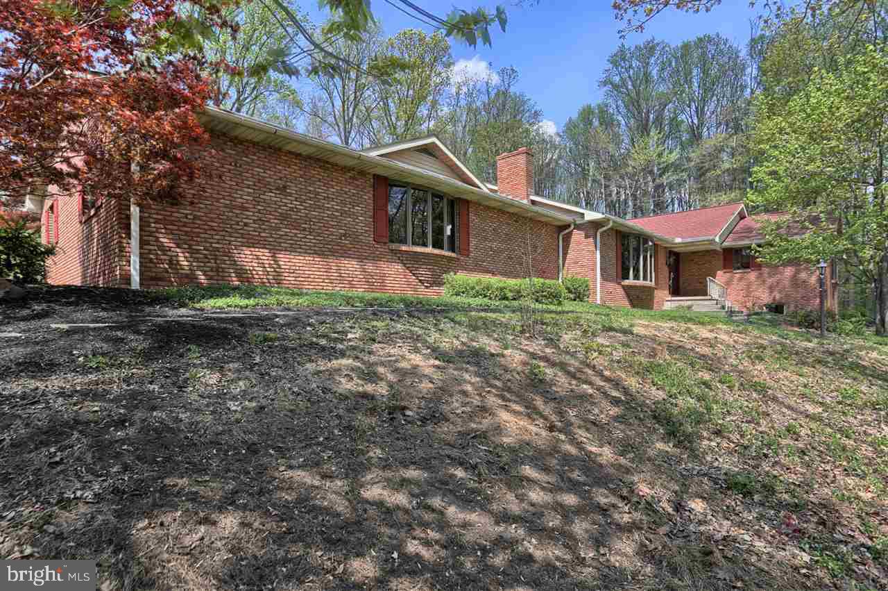 Nestled in Spring Hill Acres this all brick exterior 1 story home in, with updated kitchen that boast of Cherry Cabinets, Granite counter tops, built in appliances with a breakfast bar. Family room offers two wood burning fireplaces. The bedrooms are spacious and have great closet space. Home is well maintained! New flooring thru out!! Heated Over-sized 3 car garage. Home offers lots of built-ins. Circuit run for a generator.