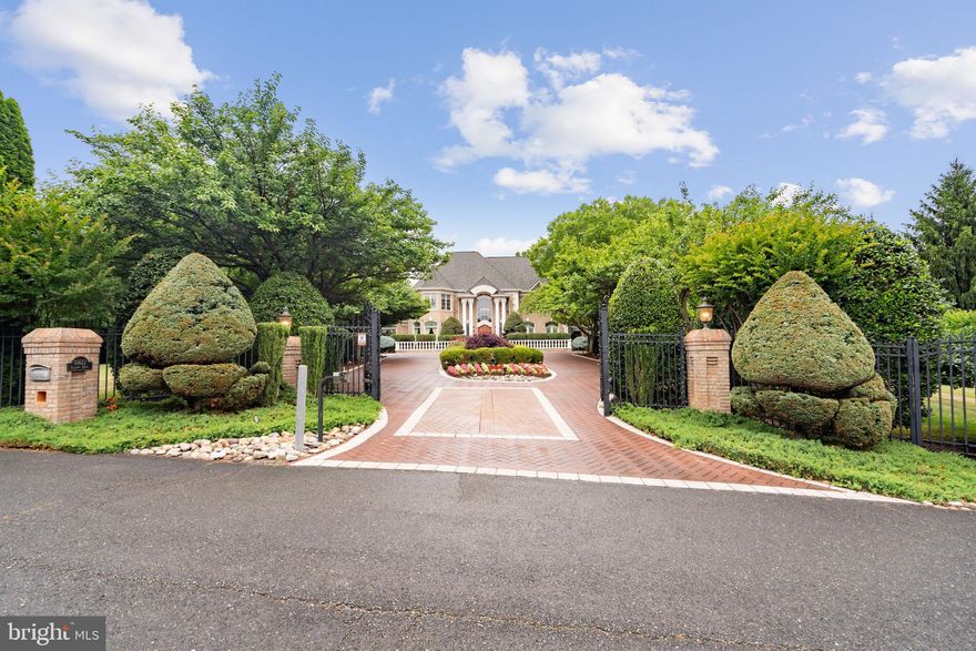 Conceived by renowned architect, John Neufeld, this nearly 12,000 s.f. gem is sited on over 2.3 acres of lush landscaping.Upon entering the gates, one is greeted by specimen plantings and an artfully designed masonry driveway.Once inside, prepare to be wowed by the22x22 Reception Hall w/marble floor,curved stairway and shimmering crystal chandelier,easily lowered  for cleaning+bulb changing by a key outlet in the wall.There is even a "Whisper Gallery" created by the perfectly formed Rotunda, at the base of the main stairway. A great conversation piece!Centered on the house and in view of the Reception Hall is the Grand Salon w/Gas FP, gorgeous soaring window wall overlooking the private grounds, and accented by the soft sounds from an  interior fountain. Banquet sized Dining Room with Crystal chandelier, three built in cabinets with mirrors, and nothing less than remarkable, plaster molding. Cherry paneled Library w/2nd  Gas Fireplace +secret bookcase door opening to Main Level Primary Bedroom Suite. Primary His and Her Bathroom connected by shower, and jetted soaking tub below a 12"-3' Cathedral ceiling. 2 Walk-in closets+ Exercise Room/Dressing Room , all in a very private suite. Butler's Pantry w/lighted cabinets leads to spacious open Gourmet Kitchen w/Island seating and rich wood cabinets. Large walk-in Pantry. Breakfast Area and cheerful Atrium/Sunroom w/ skylights over a complete wall of  Fr. Doors opening to a to a skylight  lit covered Breezeway and steps down to the Lanai. New $14,000 Sub-Zero Refrigerator, Jenn Aire Dbl Wall Ovens,Dacor Warming Drawer, Jenn Aire 5 burner Gas cook top, built-in Microwave+Beverage Refrigerator. A 3rd/4th Gas Fireplace, is Dbl Sided from the Kitchen to the Family Room. Family Room boasts16 foot peaked wood ceiling+ 2 furniture grade built-ins  book shelves. 2 P.R's on this level+ main level Laundry Room.The Laundry Room/Mud Room connect the Kitchen to the 4 Car Garage. On Upper Level, 6 Bedrooms each w/ensuite Bathrooms, hardwood floors+ Walk-In Closets. (Primary on  Main Level has His and Her Bathrooms connected by the Shower.) for a total of 6 Bedrooms, 7 Bathrooms, 3 Half bathrooms. Fabulous Home Office, w/built-in double desks, and file cabinets.The Lower Level is 4650 s.f of "Party".  33'x22.5' Rec Rm w/Dance Floor under a twinkling starlit ceiling. A Pool Table Rm, Card Playing area, Theater Room w/ built-ins+exhaust fan system to keep the air moving and fresh, 6th Bedroom w/ ensuite Bathroom and a walk in closet, plus 2 more walk-in closets one of which is cedar lined. Storage closet w/shelves 34" long. The Wet Bar is the most spectacular custom Wet Bar that you will ever see.  Replicated from one that the owners saw on their travels, reminiscent of 1930's Manhattan with backlit glass block w/ mirrors + glass to the ceiling, showcasing your most collectible spirits. Immediately adjacent is a custom designed Wine Cellar, diminutive in scale but big on style, with scenes of Tuscany as a backdrop. Throughout the house as well as outside, there is a built-in Sonos sound system with speakers and volume controls, controlled by your phone.There is a Lutron Lighting system, also controlled by your phone. Five Security cameras, and an exterior landscape misting system that keeps the specimen plantings lush. In 2017, the owners spent in excess of $500,000 on creating a double Terrace with Lanai,  Motor Court providing additional private parking for up to 8 cars, a 3rd patio adjacent to the domed ceiling Pavilion w/ Gas stainless steel BBQ Kitchen, stone terrace w/
Gas Fire Pit and a covered Bar that seats 6.There is even a Meditation Garden under a beautiful arched structure that has been the perfect backdrop for taking photos.The Potomac Ranch neighborhood is quiet, and this leg of Alloway Drive is private, therefore no cut-through traffic.  Minutes to Tyson's Corner, Bethesda, Washington, D.C. ,Potomac Village and the C+O Canal Towpath as well as the waterfalls at Great Falls Park.