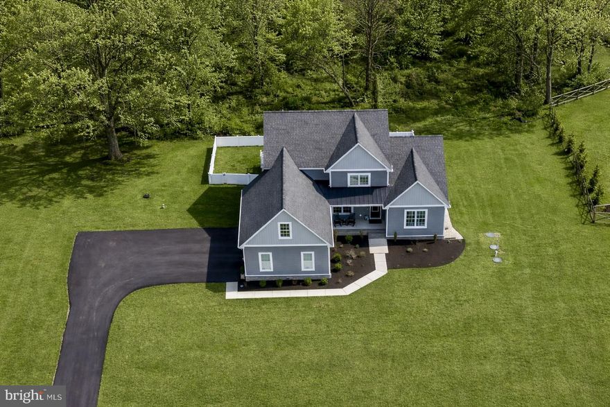 Discover an exquisite blend of modern luxury and serene living in this stunning home nestled within the prestigious Willow Branch East community. Built in 2022, this exceptional home boasts 3,011 square feet of meticulously designed space, offering an unparalleled lifestyle for those who appreciate the finer things in life. There is also approximately 1478sf of unfinished basement. Step inside to find an open floor plan that seamlessly integrates the living, dining, and kitchen areas, creating an inviting atmosphere perfect for both entertaining and everyday living. The gourmet kitchen is a chef's dream, featuring high-end stainless steel appliances, including a built-in microwave, down-draft cooktop, and wall oven, all complemented by a spacious island and ample table space. The elegant dining area and formal dining/office room provide the perfect backdrop for memorable gatherings. The heart of the home is the family room, where a stunning gas fireplace with glass doors and a stylish mantel creates a warm and inviting focal point. Recessed lighting and ceiling fans enhance the ambiance, while luxury vinyl plank flooring adds a touch of sophistication throughout. This residence offers four generously sized bedrooms, including a main-level bedroom for convenience. The primary suite is a true retreat, featuring a lavish en-suite bathroom and expansive walk-in closets. Step outside to your own personal oasis, where a spacious deck overlooks a beautiful yard that backs to tranquil trees, providing a serene escape from the hustle and bustle of daily life. The 1.42-acre lot offers ample space for outdoor activities and gatherings, while the attached side-entry garage and asphalt driveway provide convenience and curb appeal. Additional highlights include a main-floor laundry room, a tankless water heater for endless hot water, and an unfinished walkout basement with a Sauna and endless potential for customization. Enjoy relaxing in the outdoor Hot Tub located just steps away from the Sauna. This home is not just a residence; it's a lifestyle choice that embodies luxury, comfort, and tranquility. Also included are 6 wall mounted TV’s, Sauna, Hot Tub and a one year home warranty.  Easy commute to DC, the Western Shore and the Eastern Shore beaches.