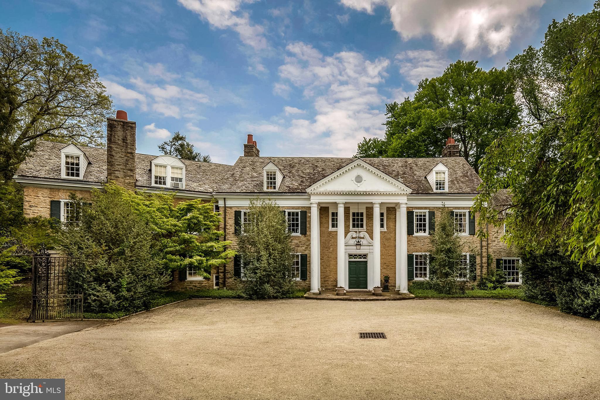Rocky Crest is off a private lane, down a winding driveway and behind an elegant wrought-iron gateway entry, this neoclassic estate built in 1906 for James S. Austin was designed by Bunting & Shrigley Architects. Classical in form, scale, proportion, and detail, its imposing, columned pedimented front fa ade makes it a grand dame residence of the Main Line. It is very privately situated on 9.47 +preserved acres (adjoins 5.5 preserved acres ). The Pew Family bought the estate in 1910, adding the pool and bathhouse in 1934 and altering the garage and stable. The Burch family purchased the property in the 1990 s and undertook a complete renovation. Its old-world features were seamlessly repaired/refreshed and modern amenities were added.You enter a grand reception foyer that runs front-to-back with French doors opening to a fabulous terrace and formal garden. Throughout the home, there are formal and intimate everyday spaces. French doors provide access to grand-scale terraces for relaxing and entertaining and, in certain bedrooms on the second floor, French doors open to small balconies with incredible views.Formal rooms are magnificent, with exquisite millwork and moldings, fireplaces, soaring ceilings and oversized sash windows as in the large elegant dining room and step-down living room/library. French doors and window surrounds provide access to another terrace and beautiful views. A beautiful paneled study is just off the living room. Its everyday spaces are remarkably inviting and comfortable. The updated, custom kitchen features top-of-the-line appliances, fixtures and finishes and includes an ample dining area and access to a cozier informal dining/family room with fireplace. The sunroom just beyond accesses a terrace for perfect al fresco dining. The private quarters are located on the second and third floors, accessible by a grand staircase, elevator or back staircase. One wing houses two-bedroom en suites, one with fireplace, and two bedrooms en suites with sitting rooms, as well as a laundry room for convenience. The larger wing of the home houses the main bedroom suite which is comprised of a bedroom/nursery/office en suite, large sitting room with fireplace, sleeping quarters, well-designed dressing rooms with custom built-ins, and his and her updated bathrooms. On the third floor, there are a plethora of rooms (now used as 5 bedrooms and one hall bathroom) that can be used at the owner s discretion, such as for weight/exercise rooms, playrooms, etc. Also, there is a generous amount of storage, including a walk-in cedar closet.The lower level is Rathskeller-like with huge fireplace and plenty of space for table games, a media room, etc. Access to this space is tucked away on the first floor through a hidden stairwell in the wet bar room.The property also boasts an Olympic-sized pool with pool house and a tennis court. A carriage house features a 4-car garage, 2 one-bedroom apartments, and, converted from stables, a wine tasting room complete with climate-controlled cellar able to hold 1,000 bottles.Its setting is breathtaking with its mix of formal gardens and extensive rolling terraced lawns and mature specimen trees. All was designed and created by the renowned 19th century landscape architect, Thomas W. Sears. This property offers perfect living for today s modern family. Add its access to the Bridlewild Trails, its proximity to some of the most highly regarded public and private schools in the country, countless near dining and shopping options, and access to major transportation modes and routes, Rocky Crest is a definite must-see!NOTE: Property has a possibility of being entered into the Agricultural #319 Act with an addition .6 acre. NOTE: Residence has a Generac partial-house electric back-up system. NOTE: House is being sold AS-IS. NOTE: This home has an Easement with the Natural Lands Trust.