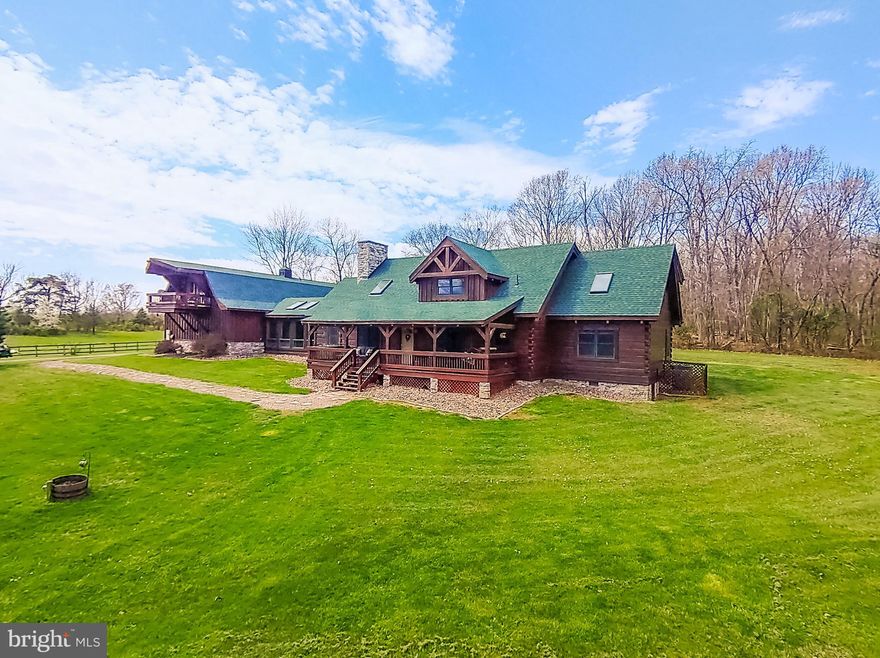 OPEN HOUSE ON SUNDAY APRIL 14TH - 11AM-2PM

"Welcome to Your Own Slice of West Virginia Paradise: Custom Timber Peg Log Home on 4 Acres "Step into the tranquility of this custom-built true timber peg log home, nestled on 4 acres of scenic beauty. Overlooking a serene pond surrounded by majestic mountains, woods, and the picturesque West Virginia countryside, this property offers an unparalleled retreat from the everyday hustle and bustle.
Key Features:
Rustic Elegance: Immerse yourself in the timeless charm of this true timber peg log home, boasting handcrafted details and unparalleled craftsmanship throughout. A hand-carved wooden spiral staircase takes you to the upper level. Stone fireplace(s) with a custom-built mantle. New Roof!,  Asphalt Driveway is two years old.
Outdoor Bliss: Relax and unwind on the oversized front porch, where you can soak in the panoramic views of the tranquil pond, rolling farmland, and wooded surroundings. Sit back on the porch swing and relax as the deer come to graze and the ducks come for a swim and the sounds of nature.
Nature's Playground: With waterfront access and acres of land to explore, this property invites you to embrace the great outdoors. Whether you're fishing in the pond, hiking through the woods, or simply enjoying the sights and sounds of nature, there's something for everyone to enjoy.
Luxurious Living: Inside, discover spacious accommodations with 4 bedrooms, 4.5 bathrooms, and a loft, providing ample space for family living and entertaining. The main floor master bedroom offers convenience and comfort, while the loft provides a versatile space for relaxation or recreation. Open floor plan is great for entertaining. Gourmet kitchen with top-of-the-line appliances.
Guest Quarters: The oversized 4-car garage features an upstairs studio apartment, perfect for guests, extended family, or even as a potential rental opportunity.
Unmatched Views: Wake up to breathtaking views of the surrounding mountains and countryside, and end each day with stunning sunsets that paint the sky in a palette of vibrant colors.
This is more than just a home—it's a lifestyle. Don't miss your chance to experience the beauty and tranquility of West Virginia living at its finest. Schedule a showing today and make this extraordinary property your own! Easy commute to MD, VA, DC!