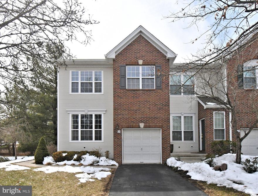 Welcome to this exceptional end-unit townhome in the prestigious community of Heritage Hills in Washington Crossing, PA. Perfectly situated on one of the most desirable lots in the neighborhood, this home backs to mature trees and offers rare side privacy, creating a peaceful setting seldom found in townhome living.  Enter through the private side entrance into a welcoming foyer with ceramic tile flooring. Gleaming hardwood floors span the Living Room, Dining Room, and Family Room, while 9-foot ceilings enhance the light and openness of the main level. The dramatic two-story Family Room is centered around a  fireplace and a striking wall of windows overlooking the private rear yard. Memories are made here! The updated Custom Gourmet Kitchen is thoughtfully designed for both everyday living and entertaining. Features include 42-inch cabinetry with detailed moldings, Granite countertops with bar seating, Stainless Steel appliances, a slide-in range with hood, built-in wine cooler, wine rack, and a custom pantry. The adjacent Breakfast Area opens to a newer deck with awning, extending your living space outdoors. Whether enjoying a quiet morning coffee or an evening glass of wine, this setting delivers privacy and serenity. Upstairs, the expansive Primary Suite offers a true retreat with cathedral ceiling, ceiling fan, two walk-in closets with custom organizers and pocket doors, and a private bath featuring dual vanities, a deep soaking tub, separate ceramic tile shower, and ceramic tile flooring. The two additional generously sized bedrooms share a well-appointed hall bath. The full basement provides abundant storage and excellent potential for future finishing to your specifications. Additional highlights include a Newer Roof (2021), Newer HVAC system (2023), Newer 80 Gallon Hot Water Heater (2022), Newer Deck  with Newer Sliding Glass Door (2022), Newer Washer & Dryer (2020). Residents of Heritage Hills enjoy community amenities including an outdoor pool and tennis courts. Ideally located near I-95, Princeton, Philadelphia, and New York, and just minutes from Washington Crossing Historic Park and the Delaware Canal Towpath for walking, jogging, and biking. All within the highly acclaimed Council Rock School District! A rare opportunity to secure a prime lot in one of Upper Makefield’s most desirable communities.