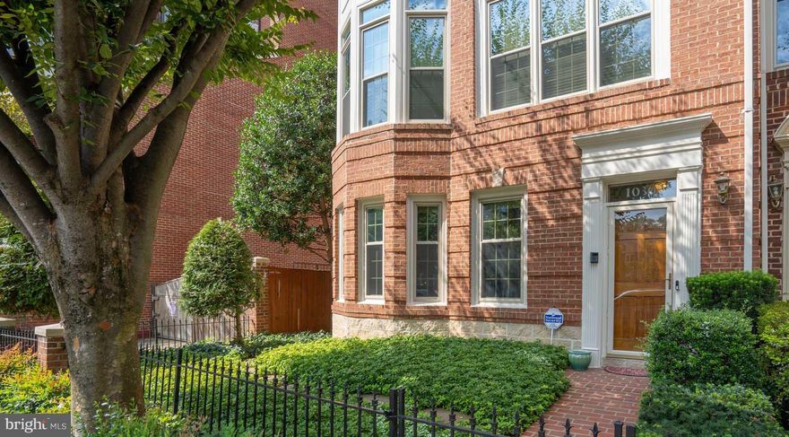 Step into this stunning end-unit townhome that has been meticulously cared for by its owner. Each room is filled with abundant sunlight, creating a bright and inviting atmosphere. Large windows, high ceilings and thoughtfully designed space. This large brick townhome features 4 bedrooms and 3.5 baths. Through the front foyer, on the left, there is an entry-level bedroom with an ensuite bath. It may also be used as an office if you work out of the home. A gas fireplace also adorns this room. A generously sized two-car garage with shelving and extra insulation is found in the rear of the townhome. The main level offers beautiful hardwood floors, a gourmet kitchen with stainless steel appliances, 42-inch maple cabinets, and custom granite with backsplash. A breakfast area is located off the kitchen. French doors lead to a generously sized outdoor deck for dining al fresco or outdoor relaxation. You will also find a generous dining area and large living area for family and friends on this level with large floor-to-ceiling windows. A second gas fireplace makes this floor cozy in cooler months. The entire third level is the owner’s suite. It has a third gas fireplace in the bedroom area, custom built-in bookcases, a large bathroom, and a generous walk-in closet. The top floor has a third bedroom with skylights and an additional fourth bedroom. Recent updates include newer paint through-out, HVAC on 1st floor (2018) HVAC on 4th floor (2021) and Roof (2018) is a unique opportunity to own a beautiful town home in a prime location. With easy access to Ballston Metro Station, public transportation and major thoroughfares,  and fabulous restaurants. The best of Arlington and beyond is at your fingertips.