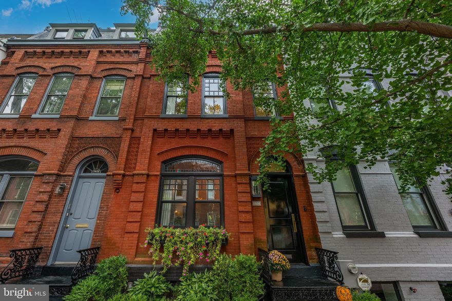 Originally built in 1885, this 5 bedroom, 3.5 bathroom rowhome was completely renovated in 2020 by Akseizer Residential.  Located on a beautiful tree-lined street, known to be DC’s most photographed street, this home is convenient to the vibrant Dupont, Logan and U Street hot spots. This special residence blends historic charm and character with modern luxury and high-end finishes. The main level features custom herringbone floors, an open living room with a gas fireplace and custom built-ins, and a spacious dining area. The chef's kitchen is a showstopper with Pietra black marble, high end appliances including a Wolf 6-burner range and a floor-to-ceiling wine refrigerator. A wall of rear windows provides loads of natural light for the breakfast nook overlooking the private courtyard/secure off-street parking. The second level offers a generous primary suite with a gas fireplace, custom built-ins and luxurious bath. Bedroom #2 opens to a private balcony. The third level includes two additional spacious bedrooms with custom closets, a full marble bathroom with brass fixtures and access to the upper roof decks with unobstructed views of the Scottish Rite Temple. The lower level has a media/recreation room with a built-in entertainment wall, a fifth bedroom, a full marble bathroom, and a well-appointed laundry room.  Easy to commute by foot or car to downtown DC, the White House, and several metro lines, this is city living at its finest! Open Saturday February 28th, 1pm-3pm.