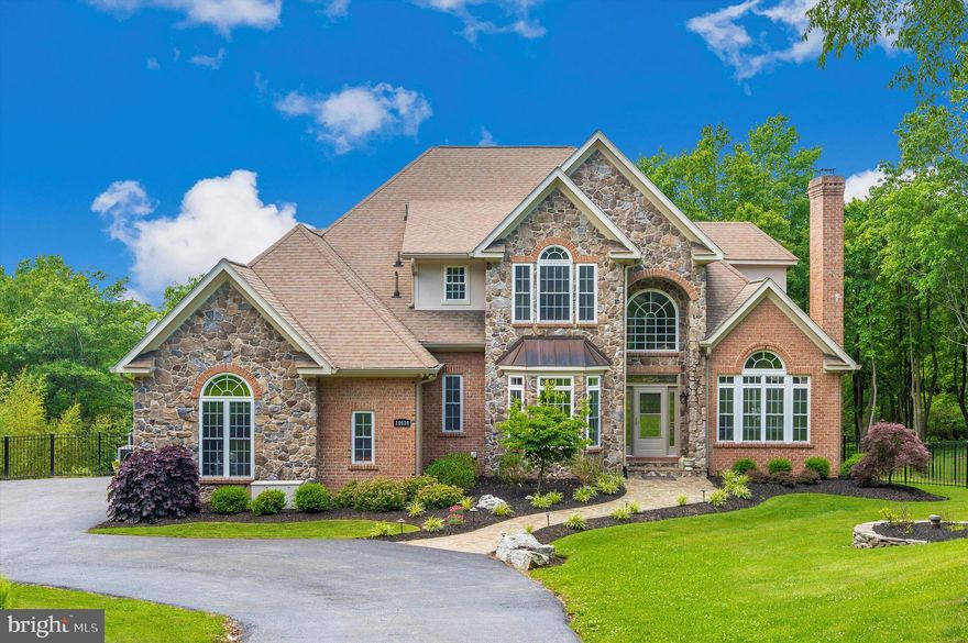 Stunning custom-built home on 6.44 acres boasting incredible views, all brick & stone, lofty windows, gleaming hardwood floors, high ceilings, and design-inspired features throughout! From the easy flowing floor plan to the spectacular outdoor living space, this gorgeous home hits the perfect balance of privacy and every entertainer’s dream; a stunning entryway, large Living with vaulted ceiling and oversized windows showcasing a profile fireplace; Dining room graced with crown molding, chair railing, and picture molding; the Family room is oversized with an embellished floor to ceiling stone fireplace. The gourmet eat-in kitchen features sleek stainless steel appliances, a double wall oven, cooktop, range hood, decorative backsplash, Granite countertops, and a casual dining area. Amazing backyard views, from the deck off the Family Room and easy access to the back yard; Main level owner’s suite highlighted an extra-large walk-in closet, and luxurious full bath with dual vanities, soaking tub, water closet, tile enclosed shower, and your private balcony; Arrival center | laundry room and powder room complete the main level; Four sizable bedrooms with walk-in closets and two full baths conclude the upper-level sleeping quarters; Travel downstairs to find the expansive recreation room, exercise or bedroom room, entertainers bar/lounge area and an additional family room with yet a 3rd stone fireplace and doors that lead you to the outdoor oasis; The exterior features professionally landscaped grounds, 3-car attached garage, covered porches, extensive hardscaped patio, private lot, hot tub, surrounded by trees, and amazing mountain views. This remarkable private estate aims to please and is truly the embodiment of Frederick’s good life! Gambrill State Park provides miles of hiking, mountain biking, and horse trails with stunning overlooks of the surrounding area, and is still close to all of the great Frederick amenities.