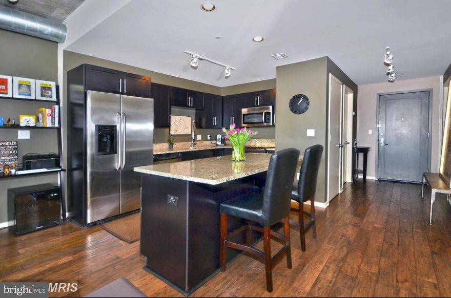 EXTRAORDINARY ARCHITECTURAL DETAILS AND AMENITIES ABOUND IN THIS LUXURY CONDO LOCATED IN THE SILO POINT COMMUNITY OF LOCUST POINT! This 4th floor unit features over 1,300 sq. ft. of living space, hardwood floors & 10ft ceilings throughout, an open floor plan with a spacious living room with a dining area, gourmet island kitchen with granite/limestone counters & ss appliances, a generously sized bedroom with a walk-in closet and a spa bath with double sinks, large soaking tub, & a separate shower, an additional half bath for added convenience, a private balcony with sweeping skyline views, and 1 car parking.  This full service building offers unsurpassed amenities including a 24hr front desk attendant, state of the art sky lounge, concierge, fitness center, meeting room, & billiards room!  This is city living at it's best!