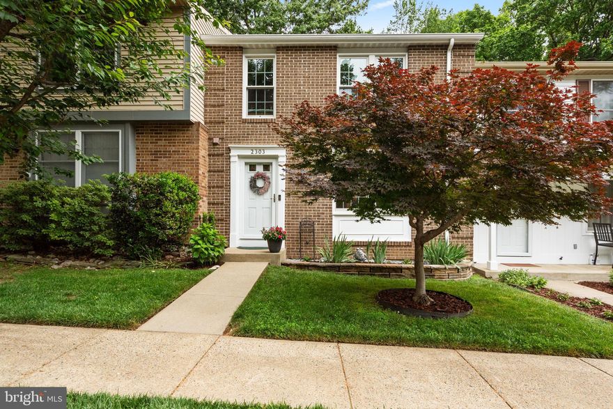 Tucked away on a quiet cul-de-sac in Reston and backing to serene wooded views, this beautifully maintained brick-front townhome offers the perfect blend of comfort, style, and thoughtful updates. Framed by mature landscaping and a stunning maple tree, the home welcomes you with timeless curb appeal and peaceful surroundings.

Inside, the light-filled main living area features a large picture window, recessed lighting, custom built-in bookcase, and gleaming hardwood floors that extend throughout the main level, stairways, upper hallway, primary bedroom, and walk-in closet. The spacious kitchen offers abundant cabinet space, updated lighting, tile backsplash, and hardwood flooring, flowing seamlessly into the dining area and out to the expansive deck through a Phantom retractable screen door — ideal for indoor-outdoor living and entertaining.

Upstairs, the primary suite features a beautifully updated bath with a frameless glass walk-in shower and custom tilework, along with a professionally outfitted closet system. Ceiling fans in every bedroom /office space provide year-round comfort. The updated hall bath showcases custom tile surrounds and flooring paired with distinctive concrete countertops.

The walk-out lower level adds exceptional living space with durable LVP flooring, recessed lighting, and a cozy electric fireplace. A large laundry and storage room includes extensive built-in shelving for organization and functionality.

Outdoor living continues with a private backyard retreat featuring a patio, substantial hardscaping, mature wisteria arbor, and tranquil wooded views from both the deck and yard.

Major system updates provide peace of mind, including Renewal by Andersen windows, screens, and doors (2018 & 2022), Rheem furnace, heat pump, and humidifier (2019), water heater (2022), washer and dryer (2023), new attic thermal acoustical pest-control insulation (2024), and roof replacement (2014). Two assigned parking spaces complete this exceptional home.