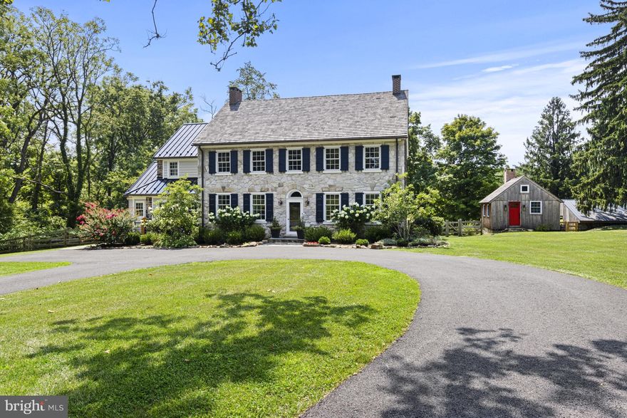 Springdale Farm is set in the heart of Pennsbury Twp in the rolling hills of the Brandywine Valley and is known for its vista views and unparalleled scenic landscapes. Originally part of the William Penn land grant, this land, including this 11+ acre lot, was home to the Mendenhall family for eight generations and is recognized as the oldest continuously run farm in Pennsylvania. It was painstakingly and meticulously brought back to life in 2019 with a top-to-bottom renovation while paying great homage to its history by having many of its original details restored in the process. It’s a truly unique property: a meticulously restored and updated Federal-style farmhouse and guest cottage in an idyllic country setting. A long driveway wends through verdant pastures to the home’s elegant façade, constructed of limestone in 1836 and crowned with a cedar shake roof installed during the renovation. The original shutters have been refurbished and new shutters added to the upper floor. A complimentary standing seam metal roof, also new, is atop the earliest section of the house, built in 1720. The sides and back of the house were crafted from local fieldstone. In keeping with modern life, an expansive deck has been added to the back of the house accessed by an addition that encompasses a gourmet kitchen that is open to a family room with a vaulted beamed ceiling and panorama views of the countryside. The kitchen is a chef’s dream—with a Wolf range, sub-Zero refrigerator, large, farmhouse-style sink and spacious pantry cupboard. A fifteen-foot island with quartz countertop seats six comfortably. White oak floors are set in a herringbone pattern. The massive granite threshold is worn by footsteps of past generations. There are two red brick fireplaces in the large living room, one of which was recently relined for use. Throughout the first floor are extraordinary architectural elements, including stately crown moldings, original raised-panel window returns, a turned back staircase, classic front door and hardware, and original chestnut wood floors. The second and third floors are devoted to four generously sized bedrooms, each with a large closet and ensuite bath with high-end finishes. The second-floor primary suite boasts a room-size closet and a newly renovated bath with soaking tub, rain shower, heated floor and dual vanity. Dormers added during the renovation on the third floor usher in natural light. In bringing back the house, the idea was to preserve the past—only better. The home was already graced with nine-foot ceilings; recessed lighting was installed during the renovation. A four-zone, state-of-the art electric and propane HVAC system ensures comfort while conserving energy. Andersen Architect Series windows combine an 18th century esthetic with 21st century energy efficiency. There’s a new septic system and artesian well equipped with a high-tech water purification system. A basement with dirt floor was dug out and a concrete floor was laid to create a space with the ceiling height to accommodate a gym, home theater, workshop or other space. Recently a generator was added. The grounds are a nature lover’s paradise, shaded by three towering sycamores more than 200 years old. The old summer kitchen has been reinterpreted as a gardening shed and studio equipped with a wood-burning fireplace. Two other outbuildings act as storage for a tractor and other outdoor equipment with 2 tractor stalls recently converted to animal pen with fencing. Springdale was named for the three natural springs that still wind through the property. The original spring house is now a delightful one-bedroom guest cottage which was restored along with the main house and is complete with a kitchenette, living space, large bedroom and bathroom. Indulge in this private modern oasis with close proximity to  Amtrak, Philadelphia airport and shops and restaurants.