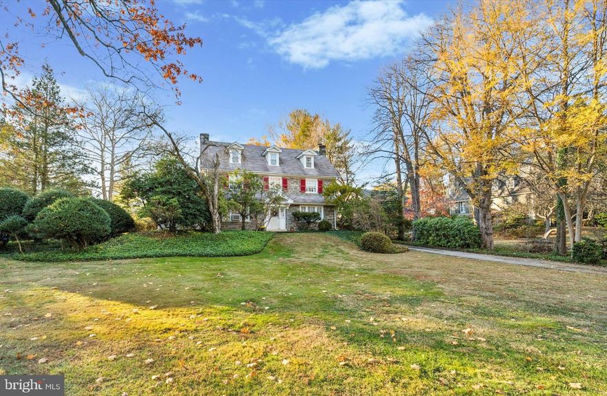 Welcome to an exceptional home that has been loved by the current owners for almost 60 years.
Sitting elegantly amongst mature trees, green lawns and manicured gardens in this highly desirable neighborhood, this stunning three-story, Stone Colonial masterfully blends classic charm with comfortable living. 
A wide brick walkway invites you up to the front door, hinting at the beauty within. Upon entering, you’re greeted by height, light and space with an open center hall and a grand staircase that immediately captures the essence of timeless elegance. 
Grand windows fill each room with natural light, while deep-set windowsills and hard wood floors add warmth and character throughout.
The first floor boasts a formal living room with a striking picture window overlooking a large patio, in-ground pool and expansive back yard. Here you can sit for hours on the window seat and view nature’s spectacular show which is your own private oasis away from the hustle and bustle. A beautifully appointed fireplace and built-in bookshelves make this room perfect for both quiet evenings and entertaining guests. 
The formal dining room, also complete with elegant fireplace and built-in cabinetry is an inviting setting for formal or casual dinners, not to mention lively celebrations. 
Off the living room enter a sun-soaked den with a third and impressive, stone fireplace, rows of sill to ceiling windows and an exit to the rear patio, providing a more informal, relaxed space to enjoy family time and perhaps, pop out for a swim in the pool. 
The walk up the stairs to the first landing showcasing your expansive backyard through the great picture window convinces you each time you arrive there, this home is truly a magical place.
Take three more steps to find three spacious bedrooms and two full bathrooms on the second floor. The primary bedroom is as grand as the living room with beautiful light, space and privacy from the other rooms. It boasts a walk-in closet and an ensuite bath with a full tub/shower. 
On the opposite side of the house is a large room with perfect light which can be a bedroom, office or big dressing room. 
A third large and private bedroom with full bath with tub/shower, a deep inset cedar closet and a spacious linen closet with built-in shelving complete to this floor.
Ascend the open staircase to the third floor, where three additional
bedrooms await, oﬀering flexibility for family, guests, or a private home
oﬃce.  A full hall bathroom with a classic clawfoot tub along with a generous storage room, providing ample space for both comfort and organization complete this floor. 
The kitchen overlooks the patio and gardens with windowsills basking in warm light where plants thrive and windows to the ceiling offer wide views of your backyard. 
The most active room in the house offers a gas stove, dishwasher and plenty of cabinets and prep space. There is also a walk-in butlers pantry featuring wall to wall cabinets for plenty of storage, a powder room and a mud room with an exit to the driveway.
Outside, the expansive grounds oﬀer beauty, peace and tranquility. The mature landscaped yard features a lovely patio with brick walls, colorful gardens, a sparkling in-ground pool complete with pool house offering 2 changing rooms and bathroom - perfect for summer relaxation or entertaining.
Additional features of this home include a full basement with laundry area, a finished room and plenty of storage room. There is a two car detached garage with a finished loft space above- ideal for a home-oﬃce, yoga or creative studio. 
Situated within the award-winning Lower Merion School District, 402 Penn Road combines elegant living with ultimate convenience