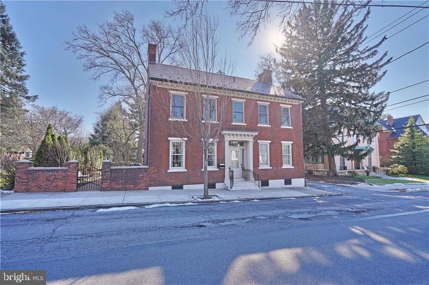 Located in the heart of Historic Bethlehem, this distinctive Moravian home epitomizes the renowned architecture of one of the area's most culturally rich neighborhoods. 19th century architecture featuring 9.5' ceilings & wide moldings blends w/modern amenities such as updated butler pantry & kitchen w/quartz counters, Carrera marble backsplash & high end appliances. Sunroom w/Moravian tile floor offers great views of private courtyard/garden. Back staircase leads to the second floor where an expansive master suite w/sitting area, bath & closet/dressing room is a peaceful retreat. Three more bedrooms, full bath and workroom complete this level. Spacious home office, half bath & exercise room comprise the 3rd level. Attached 2 car garage & off st parking for 4 vehicles is a rarity in town! A carriage house, used as storage, could become a studio. Stroll past historic museums & sites to Main St shops & restaurants and become part of a sophisticated urban lifestyle in this much loved city.