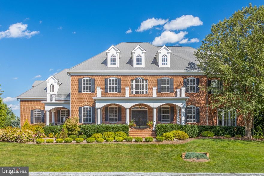 Here you can live, love and play in a gorgeous custom home boasting almost 10,000 square feet on 3 levels. The open floor plan design and amenities offer something for everyone inside and out. Located in a beautiful Gary Player Signature Golf Course Community on over 900 acres with only 205 single family homes. Conveniently located  minutes from the Town of Leesburg, local restaurants, wineries, breweries, farm markets and the Potomac River. This is a premier 1+ acre lot that adjoins another 10+ acres of dedicated open space with scenic views of the mountains and 3rd Fairway.  Enjoy the welcoming covered front porch and enter through double doors into the modern foyer. The main level features 10’ ceilings, 8’ interior doors, wrought iron balusters, hardwood floors, designer lighting and extensive millwork. The floor-plan flows from one room to another connecting the indoor and outdoor living space. The main level features a large dining room, perfect for everyday living or grand scale entertaining with seating 14+.  The main level also offers a private study with French doors, a light and bright chef's kitchen with over-sized windows, two large center islands with granite counters, upscale stainless steel appliances, two dishwashers, 2 ovens, speed cooker/microwave, island prep sink and  access to large covered porch, deck and outdoor grilling area.  You will savor cooking or sharing a great meal with friends and family in this well designed kitchen while still feeling connected to other activities in the family room or outdoor living area. The kitchen dining area opens to the family room which is the heart of the home and provides another access to the covered porch.  Your friends and family will have so much fun they may never want to leave!! On the upper level you will find a relaxing primary luxury suite with sitting room, fireplace, spa-like bath with granite counter-tops, designer lighting, glass enclosed shower, and two large walk-in closets. In addition to the primary suite you will enjoy an upper level laundry room, 3 additional secondary bedrooms each with upgraded en-suite baths and a secondary back staircase which conveniently connects the upper level to the main level mudroom and garage. The walk-out lower level is a great space to relax, unwind or entertain with over 3,000 additional square feet of living space. Watch a movie or sports event, play pool or ping pong, snuggle up to the bar and enjoy a glass of wine.  Friends and family will love the opportunity to enjoy the amenities of the lower level which includes an additional bedroom suite with large windows, full bath, an over-the top media room, exercise room or second office with adjoining full bath,  full custom stone bar, bonus room or game room and walk-out access to your fully fenced backyard oasis, covered  patio and fire pit. The landscape has been professionally designed, loved and enjoyed with a variety of specimen trees, flower beds and multi zone irrigation. You will love the convenience of living so close to the community golf club house, swimming pool and tennis courts. Residents also enjoy convenient access to the well known restaurants, shopping, regional parks, trails, wineries, breweries, farm markets, historic sites and sought after open space. Truly one of the greatest places to live! This home is easy to show, all lights will be on, doors will be open and Covid 19 guidelines followed. Video tour coming soon.