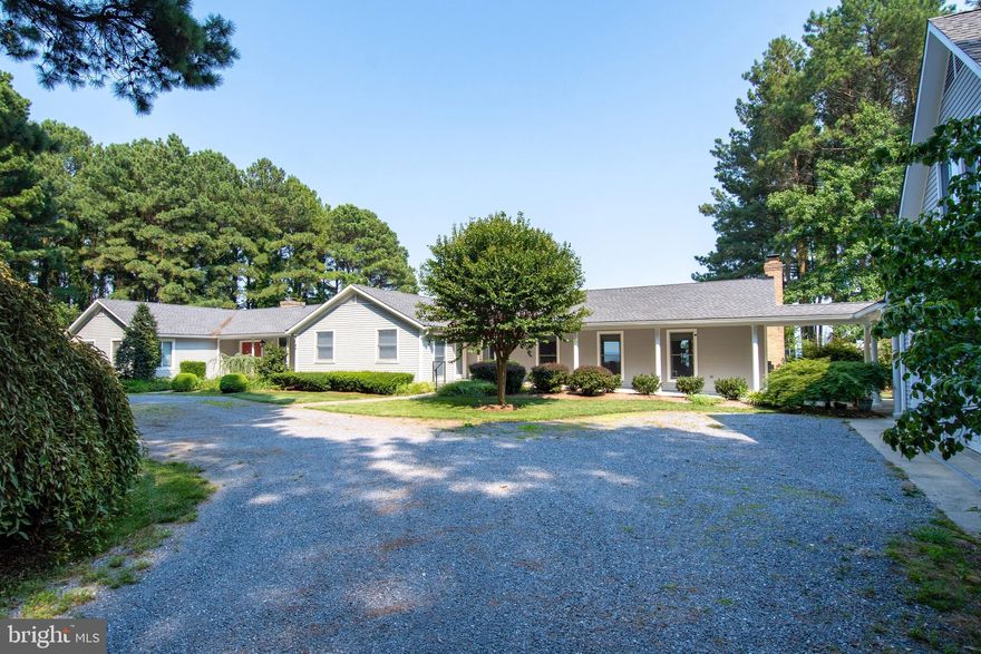 A haven of tranquility, located on Eastern Bay!  A fluid living space with seemingly endless destinations. The heart of the home features a large stone fireplace & vaulted ceilings, topped off with sliding doors and big views of Eastern Bay. An additional family room was added to the original home, creating a large gathering area. Beyond the primary residence, there are two additional living quarters.  
The second living quarter is connected by a  breezeway, with an owner's suite, full bath, a second bedroom & bath, a beautiful kitchen, living room,  fireplace, and porch. The third living quarter offers one bedroom & bath, full laundry & small kitchen space, with an open floor plan.  All conveniently located over the three-car garage. Details of the property go on and on.  It includes 2 piers.  One is located on Eastern Bay with 400 feet of rip-rapped shoreline. The second pier is located on Holligan Snooze Inlet.  There are 3 acres of open space and the rest is mature woods for camping, walking, or enjoying the wildlife. Panoramic views with sunrises to start your day.