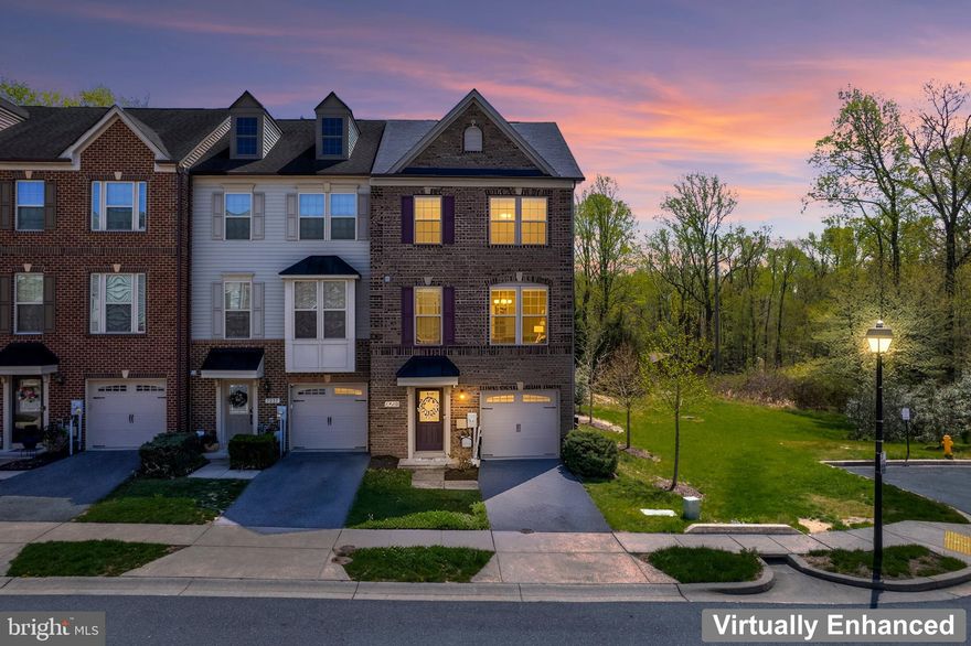 Impeccably maintained brick end-of-row townhome in the sought-after Parkside community, offering 3 finished levels of refined living.

The lower level features a versatile walkout suite with 3rd full bath, ideal as a guest retreat, 2nd primary suite w/not 1 but 2 walk-in closets, or recreation space, plus access to the attached 1car garage.

The main level is designed for entertaining, showcasing an open-concept layout with beautiful hardwood flooring and a gourmet kitchen featuring an expansive granite island, stainless steel appliances, ample cabinetry, as well as a half bath off of the sun-filled living room.

Upstairs, the 1st primary suite offers a tray ceiling, walk-in closet, and en-suite full bath w/separate tub and shower. 2 additional bedrooms, a flexible loft space, upper-level laundry room w/full sized washer and dryer, and a 2nd full bathroom complete the upper level.

Enjoy a private rear deck backing to woods. Community amenities include a pool, fitness center, walking trails, and playgrounds. Conveniently located near NSA, Fort Meade, BWI, and major commuter routes between Washington, D.C. and Baltimore. Parkside makes coming home and staying there incredibly pleasing.