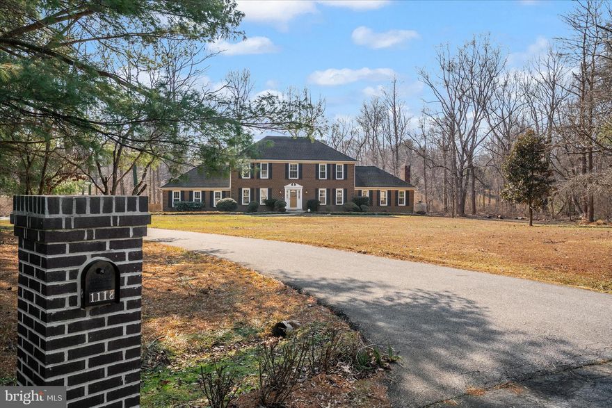 This is the one buyers wait for — real space, real land, top-tier schools, and a floor plan that truly works — all at a price point that still leaves room to make it your own. Tucked at the end of a quiet cul-de-sac on two private, wooded acres, this Rutland Estates home offers the kind of scale, light, and natural flow that newer construction often struggles to replicate.  The layout is exceptional. A dramatic great room anchored by a wood-burning fireplace opens seamlessly to the kitchen, creating a true heart-of-the-home feel that’s perfect for everyday living and effortless entertaining. The kitchen itself is oversized and thoughtfully designed with double ovens, stainless steel appliances, a center island with a second sink, and breakfast bar seating — ideal for anyone who truly enjoys cooking and gathering with family and friends.  A formal dining room provides the perfect setting for holidays and celebrations, while the screened porch and adjoining deck extend the living space outdoors, overlooking a peaceful wooded backyard that feels private and serene.  The main level also includes a flexible bedroom or office, ideal for today’s work-from-home lifestyle or guest space. Upstairs, the primary suite is generously sized and complemented by additional bedrooms and loft-style architectural elements that add character and a subtle modern edge rarely found in a traditional colonial footprint.  The walk-out lower level is where the opportunity really shines. The space has already been started, with portions finished and others underway, giving the next owner a valuable head start. With a little imagination, it could easily become an incredible lower-level retreat with room for a rec room, gym, media lounge, guest suite, or even a future kitchenette and full bath. The groundwork is there — it simply awaits the finishing touches to transform it into something truly spectacular.  This is not a flip.  This is not builder-basic.  This is a home with strong bones, beautiful proportions, privacy, and tremendous upside for a buyer who understands value and long-term equity.  All of this just minutes to Route 50 with easy access to Annapolis, Washington DC, and Baltimore, and zoned for Davidsonville Elementary, Central Middle, and South River High — some of the most sought-after schools in the region.  Two acres. A smart, livable layout. Endless potential.  Homes like this — with this much land, in this school district — rarely come along and never last long.