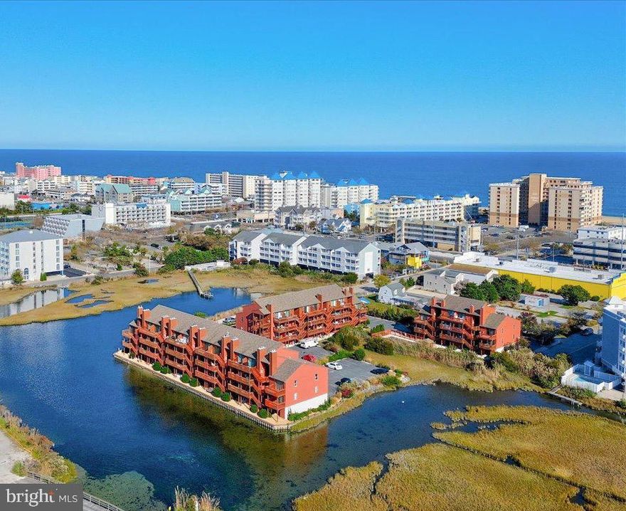 Your home away from home awaits your arrival! Situated in the Sunset Landing Community, this first floor direct bayfront condominium has it all! Just park your car in your assigned space (directly under the unit)  and unwind! This home has been lovingly maintained by its owners and was FULLY RENOVATED in 2020 followed by updates and improvements in 2021, 2022 and 2023.  This home features two balconies with slider doors- one on the bay side (new DOOR n 2020) and two on the bedroom side (new DOORS in 2023) which allows for a beautiful cross-breeze in the unit.  It features a living room, updated kitchen, primary bedroom with walk in closet and ensuite bath with access to balcony, second bedroom with access to balcony, laundry room,  assigned storage unit and covered parking. The eat in kitchen has white upgraded cabinets with loads of storage, quartz countertops, and updated appliances,  This home has views for miles, short walking distance to the beach, bars and restaurants, outdoor pool and a storage shed for all your water toys.  Enjoy the fabulous sunsets, fireworks, bird-watching, and sea life from the enjoyment of your balcony.