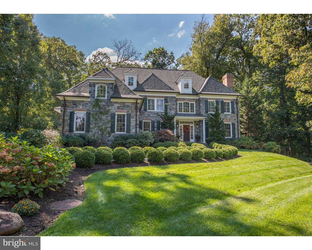 Situated on a scenic, private 1.2 acre lot, this impeccably-maintained home offers the ultimate in elegance and comfort for today's living. Surrounded by mature trees, plantings and perennial gardens, this beautiful stone colonial features an open floor plan, 9-ft ceilings, gleaming cherry wood floors, an outdoor stone fireplace and patio which create an inviting and comfortable atmosphere for both formal and casual entertaining. The two-story foyer is welcoming and leads to spacious rooms, arched doorways, built-ins and sun-filled rooms. The living and dining rooms are elegantly appointed and the office with built-ins is positioned for a quiet escape. The family room boasts custom built-in cabinetry with beverage refrigerator, granite and marble wet bar, beautiful gas fireplace and french doors which lead to the flagstone patio with gorgeous stone fireplace and hearth. The gourmet kitchen features professional-grade appliances, a huge island, walk-in pantry, separate breakfast area which overlooks the beautiful grounds. There is a back staircase, mudroom with powder room and access to 3-car garage. The second floor offers an exquisite owner suite with separate sitting area, walk-in closet and and elegant marble bathroom. There are four additional bedrooms, 2 have en suite bathrooms and 2 share a double-sink bathroom. On the third level, you could have a sixth bedroom with en suite bath and tremendous storage areas or use as a play/study room or as a nanny/in-law suite. The fully-finished lower level is a welcome retreat featuring a full bath, walk-out entrance, windows which allow for sun-lit space, various storage areas, gaming, theater and exercise spaces. Generator added for peace of mind. This magnificent home is conveniently located and only minutes to schools, parks, major transportation hubs/roadways, shops, restaurants and is in the award-winning Radnor School District.