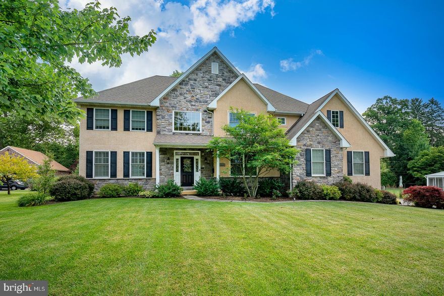 Welcome to 3035 Hermosa Lane, a stunning two-story stone and stucco colonial home built in 2012, situated on a verdant, fully fenced, half-acre lot in the sought-after neighborhood of Merion Golf Manor. This lovely home offers nearly 4,000 sqft of above-grade living space with 4 bedrooms and 3.1 baths, providing ample room for comfortable living and entertaining. As you step into the light and airy two-story entry foyer, you are greeted by a turned staircase, splendid arched entryways, and gleaming hardwood floors. The foyer leads to a nice-sized office or den with French doors and a convenient powder room. The formal living room features crown molding and plantation shutters, creating an elegant atmosphere. The spacious dining room, overlooking the rear grounds, boasts a tray ceiling with recessed lighting. The heart of the home is the open-concept kitchen and great room. The kitchen is equipped with cherry cabinetry, granite countertops, a pantry closet, an island for seating, stainless steel appliances including a double oven, and an eat-in area adjacent to the door leading to the deck and yard. The great room impresses with its two story cathedral ceiling, numerous oversized windows that flood the space with natural light, a fireplace with a marble hearth and surround, a beautiful built-in bookcase, recessed lights, a ceiling fan, and back stairs to the second level.
Completing the main level is a mudroom with a large coat closet and built-ins, a laundry room, and access to an oversized three-car garage. The second level features a luxurious primary suite with a sitting area. The primary bath offers two separate vanities, a soaking tub with attractive tile surround, a walk-in shower stall with bench, and a separate water closet with a window. The dressing area includes two walk-in closets and a vanity table with a mirror. Bedrooms two and three are generously sized, while bedroom four is ensuite with an attractive vanity and shower-tub combination. All bedrooms have spacious closets. The hall bathroom has a double sink vanity and separate toilet and tub/shower combo. The lower level, with its high ceilings, is enormous and ready for your customization. This home is designed for entertaining, with the kitchen and living areas opening to the beautifully landscaped, fully fenced backyard, featuring a Trex deck and a large paver patio with a built-in fire pit. The mature and striking perennial gardens and trees were planned to flower at different seasons throughout the year.  Located in the Haverford School District, this home provides easy access to the amenities of the Main Line, restaurants and shopping, township parks, farmers markets, major thoroughfares, and the High-Speed Line and R5 train providing access to Philadelphia. This home presents a wonderful opportunity to experience the best of suburban living.