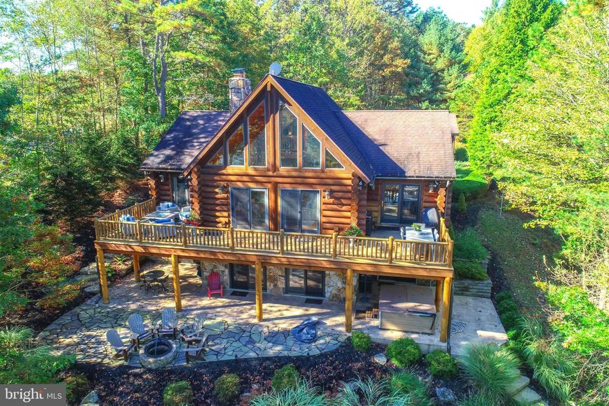 An extraordinary lakefront sanctuary awaits on this pristine 2-acre parcel representing a rare opportunity within  Deep Creek Lake's coveted Pergin Farm. This incomparable custom residence captures the essence of  mountain lake lifestyle living  with vaulted ceilings, dramatic native stone fireplaces, and territorial views across the lake and surrounding mountains. Log crafted with standing dead lodge pole pine from Yellow Stone. Nature and luxury converge in perfect harmony, offering unprecedented privacy coupled with flexible creative spaces. Boasting 195' of lakefront, boat slip, 5 bedrooms, 3.5 bathrooms, and detached garage. An open floor plan, lakeside deck, and a walk out lakeside patio too! A story book lakefront log home setting....  Access to the water is effortless, with hardscape steps off the lower level patio leading to the dock. A utility-friendly trail for golf carts or UTVs which can be entered from the top of the driveway—either from the road or beside the trash enclosure—as well as behind the garage.