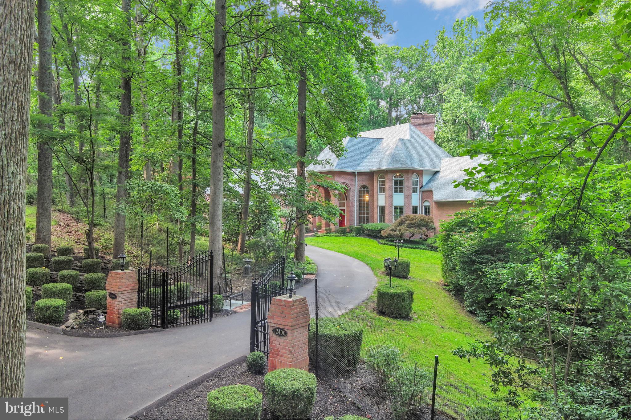 Welcome to 12400 Tridelphia Lane, Ellicott City – a private estate that truly has it all. Step into timeless elegance and unmatched comfort at this grand estate home, gracefully situated on nearly 8 wooded acres of pure serenity. From the moment you enter the gated drive, you’ll sense the privacy and prestige that define this exceptional property. Inside, the home is adorned with impeccable taste and luxurious finishes. A dramatic spiral staircase greets you in the grand foyer, setting the tone for spacious living throughout. With multiple family rooms, recreation areas, and not one but two full kitchens on both upper and lower levels, this home is tailor-made for multigenerational living or effortless entertaining. There are bedrooms galore, offering comfort and flexibility for any lifestyle. Outside, nature takes center stage with meandering paths, tranquil ponds, cascading waterfalls, and extensive landscaping that creates a retreat-like setting. Enjoy expansive decks, an irrigated yard for easy maintenance, and a three-car garage. Whether you’re seeking luxury, space, privacy, or a blend of all three, this home must be seen to be believed.