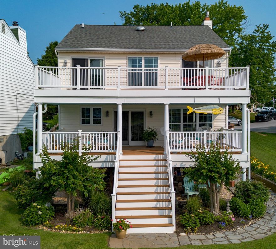 This stunning waterfront property offers big, Eastern water views of Middle River and 6​3 feet of prime shoreline. Enjoy the coastal lifestyle with a private​ 70' pier​ that includes 10'x20' platform, featuring an 8,000 lb boat lift (with remote)—perfect for boaters and water lovers alike. The huge covered ​ waterside porch offers a relaxing retreat​ off of the Kitchen and Living Room. There is also a full , 28'x12' d​eck,  above, accessible from both the primary suite and Bedroom 3/Office​.

Inside, the open floor plan is perfect for entertaining, with gleaming​, newly refinished hardwood floors throughout the first floor. A formal Dining Room  with coffee bar, flows into a beautifully updated kitchen complete with GE stainless steel appliances, granite countertops, a stone backsplash, and gas cooktop—all with a panoramic water view​s. The ​g​igantic adjoining  living room includes a cozy propane gas fireplace​, and recessed TV nook. There is also a first floor Powder Room .

The Second Floor features a huge Primary Suite,  with a gorgeous water view,  sexy ensuite bath  with  dual sink vanity, a separate shower, soaking tub, a sliding barn-door, and a huge walk-in closet with  pull stair to attic. The Laundry, on this level, features a Speed Queen washing machine and Speed Queen electric dryer.  Three more  Bedrooms and a recently remodeled Hall Bath with shower, and a linen closet rounds out this level.  The Electric heat pump is in the attic.  An unimproved basement, with sump,  is  terriffic for storage.  Additional storage, under deck, provides dedicated covered storage for kayaks,  canoes,  or other toys.  

Breathtaking sunrises  make every morning feel like a getaway. This is coastal living at its finest!