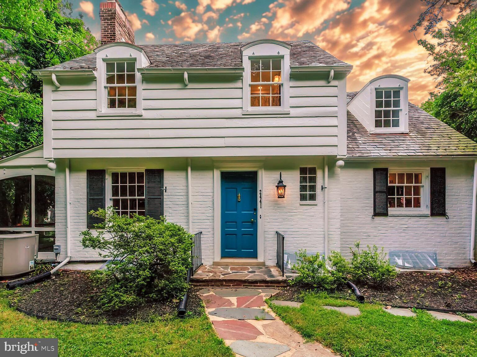 Tucked along the wooded banks of the Gwynns Falls, the historic village of Dickeyville offers something incredibly rare in Baltimore: a true sense of place. Here, the year moves not by the pages of a calendar, but by traditions passed from one neighbor to the next. In spring, residents gather with gloves and garden tools for the village clean-up, tending to cobblestone walkways and 19th-century stone walls with care. Summer arrives with bunting draped across porches and the hum of preparations for the neighborhood’s beloved Fourth of July celebration—a multi-day festival of homemade parades, open-air concerts, potluck dinners, and a pie bake-off that draws laughter and applause from every corner of the village. Fall brings cooler air and a communal bonfire, where stories are shared over bowls of chili and music drifts through the trees. Halloween transforms the neighborhood into a glowing patchwork of carved lanterns and creative porch displays, while winter offers door-to-door caroling, a cozy pancake breakfast, and a progressive New Year’s Eve dinner, each course served in a different warmly lit home. All year long, neighbors stop to chat on daily walks, join garden tours hosted by the local club, and take full advantage of the miles of trails and parkland that wrap around the village like a green belt of calm. In the heart of this storybook setting sits a beautifully updated 1940s colonial—your opportunity to become part of the fabric of Dickeyville without the maintenance demands of the village’s oldest homes. Offering over 3,000 square feet across three finished levels, this home is rich in character, with original hardwood floors, exposed stone walls, copper and brass details, and two working fireplaces that make each season feel a little more magical. The remodeled kitchen opens to a flexible dining or living space, and the home’s layout includes an optional main-level bedroom or office with its own private porch entrance—ideal for quiet mornings or remote work. Upstairs, spacious bedrooms and elegantly updated bathrooms offer comfort and timeless appeal. The finished walk-out basement adds a generous rec room, a full bath with industrial loft touches, and ample storage. Outdoors, the home sits on one of the largest lots in the village, fully fenced and adorned with mature trees, decorative hardscaping, and multiple outdoor living spaces—including an elevated patio, original flagstone terrace, and a serene three-season screened porch. With two single garages, a private driveway, and a prime location just steps from trails, parkland, and the river, this home offers a unique chance to step into a life where history, nature, and community intersect. Dickeyville is a registered historic district with an optional HOA of just $50 per year—proof that something truly special doesn’t have to come at a premium. Come take a walk through the village, meet a neighbor or two, and see for yourself what makes Dickeyville not just a place to live, but a place to belong.