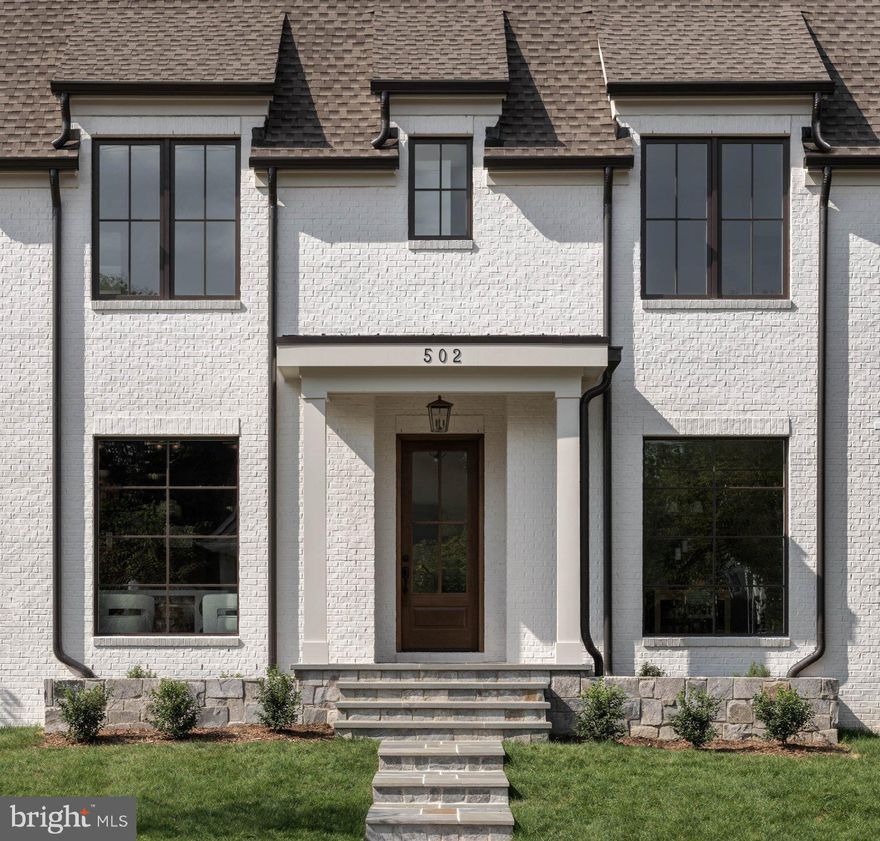 Welcome to 502 North Jackson - Ten Penny Homes presents another stunning new build in sought after Ashton Heights. This gorgeous Colonial Farmhouse dwelling  is perfectly situated on a large, flat corner lot  north of Pershing Dr. and features over 6,300 finished square feet expertly spread out over 4 floors. With 6 bedrooms, 6 1/2 baths in the main house, and a detached garage with a fully finished 1 bedroom/ 1 bathroom loft to use as your own personal workspace, bedroom, or au pair suite. 

Inside the main home, you are greeted across the foyer by the home studio with custom built in cabinetry and lighting. The dining room, enveloped in elegant wainscotting connects to the Thermador clad chef's kitchen through a butler's pantry and walk in. Once in the open chef's kitchen, unwind at the custom built 10 foot island with bar seating and look out into the open living area and fireplace surrounded with  custom milled mantle piece . A breakfast nook looks out to the backyard and flagstone covered porch, while a mudroom with built in cabinetry and storage connects through the back of the house. 

The primary suite upstairs is it's own wing unto itself. Connecting to the other 3 bedrooms and laundry room through paneled French doors off of the main staircase, its' vaulted, tray ceiling leads the eye towards the luxurious master bath with heated floors, double vanities, soaking tub, and oversized walk in shower. 2 separate walk-in closets off of the main bedroom complete your private oasis. All 3 additional bedrooms on the 2nd floor are outfitted with their own bathrooms and walk in closets. A private loft upstairs has it's own bedroom and bath with a large bonus room perfect for a study or craft space.

Entertain your guests on the lower level with a large recreation space outfitted with custom 4 zoned wireless speakers and subwoofer throughout the house, a wet bar, large finished walk in to convert to a wine or bourbon cellar, and fitness room. A 6th bedroom with en suite bath rounds out a marvelous property waiting for you to call it home.

502 North Jackson is the perfect blend of private oasis inside an urban setting with incredible access to Clarendon, Ballston, and all that Arlington has to offer.  Ten Penny Homes offers a 1 year wall to wall workmanship warranty, 2 year mechanical, and 10 year structural warranty with all of their builds. All mechanical is covered under manufacturers warranty.