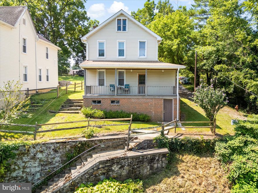 Charming 1910 Colonial with Modern Updates in Brunswick.  Perched high above the street with tree-lined views, this move-in ready 4-bedroom, 1.5-bath Colonial offers 2,020 finished sq ft of living space that blends historic charm with thoughtful updates. Relax on the front and rear porches and take in the peaceful setting, or enjoy the convenience of a level rear entrance with paved off-street parking and a shed for extra storage. Inside, you’ll find original refinished wood floors, tall ceilings, spacious rooms, and a wide staircase that enhances the home’s open, airy feel. The kitchen features stainless steel appliances, a brand-new refrigerator, a freshly tiled backsplash, and a pantry. A built-in hutch adds timeless character, while the floored attic and unfinished basement provide excellent storage options. Major updates include a new roof (2023), new gutters (2023), new sewer main (2024), dual-zone HVAC (2019), 200-amp electric (2019), updated plumbing (2019), replacement windows, and a rebuilt front porch (2019). Set on a 0.21-acre lot on a quiet residential street, this home offers the perfect balance of privacy and accessibility. Just a short walk to the Historic Main Street, Brunswick High School, the MARC train, and the C&O Canal towpath, it’s a wonderful spot for commuters and outdoor enthusiasts alike.