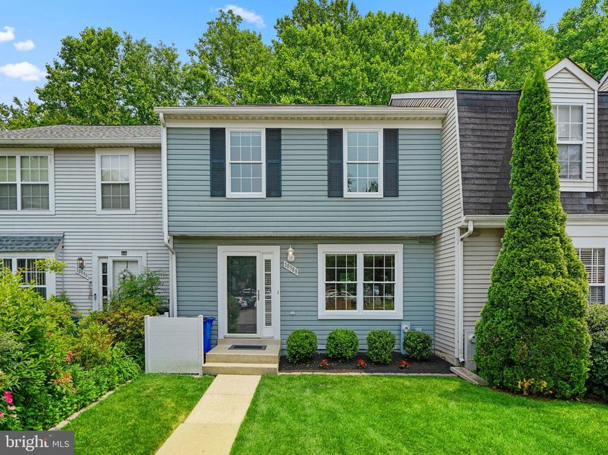 Located in popular Hickory Ridge is this upgraded townhome featuring rich hardwoods spanning the main  and upper levels, a front kitchen equipped with a bright double window, sleek quartz counters, raised panel wood cabinetry, stainless steel appliances, a center island with breakfast bar, and a view of the living room and dining room. At the end of the foyer you find a dining room with a pass-through window to the kitchen for ease in serving and recessed lighting that carries to a light-filled living room with a central fireplace and a glass slider stepping to a low maintenance Fiberon deck. The owner's suite presents wooded views, a built-in armoire, double closets, and a private bath with a LED mirror, a walk-in shower with color changing LED overhead, Bluetooth speakers, penny tile, plus stylish surrounds and built-in bench. Additional space is found in the lower level highlighted by a rec room with a full bath, a laundry and utility room, extra storage, and a walkout to a paver patio with a wooded view. There are 2 assigned parking spaces, #33 and #74. Adding ideal convenience to everyday life, this home is just moments away is shopping, dining, entertainment, parks, commuter routes, and more!