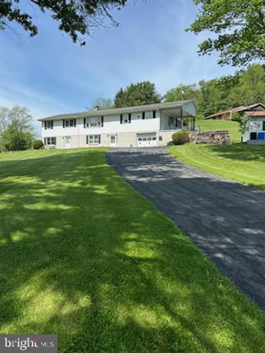 Country Living - Come see this large Ranch Home with attached Mother- in- Law suite . This home has plenty of room and storage. the main floor boasts a large Eat-in-Kitchen, Living Room, 3 Bedrooms and 1.5 Baths. A covered porch off the kitchen to enjoy your morning coffee or nature watching. Main floor Mother-in-Law suite provides a Living Room, Kitchen, Bedroom and Bath and a covered porch at rear of home. The walk in basement has a large Family Room with a fireplace with wood stove attachment, a utility room with a shower and an attached one car garage. Mother in law sweet basement provides a finished room that could have various uses along with a storage area. 2-200 AMP Electrical Service. Public Sewer and Well Water. 3 outdoor sheds, 1 of these with electrical service.
Home is being sold AS IS.
Baseboard electric heat plus Woodstove. Walk up attic.