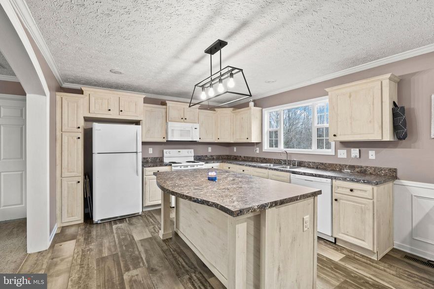 Open house on Sunday 2/22 canceled due to weather. Postponed to Saturday 2/28 11-2. Discover your dream home in the serene Woodford community, where modern comfort meets nature's tranquility. This stunning ranch-style residence, built in 2020, boasts 1,512 sq. ft. on a 2.95-acre lot. Meticulously designed living space, perfect for those seeking a blend of style and functionality. Step inside to find an inviting open floor plan that seamlessly connects the living, dining, and kitchen areas. Enjoy the convenience of a main-level bedroom and a luxurious primary bath with a walk-in shower, ensuring comfort for everyone. The interior is adorned with plush carpeting and luxury vinyl plank flooring, while double-pane windows provide energy efficiency and a peaceful ambiance. Modern appliances, including a built-in microwave, dishwasher, and electric range, make daily living a breeze. Outside, the property spans nearly 3 acres, offering a private retreat that adjoins open space and backs to lush trees. Enjoy the beauty of nature from your rear yard, perfect for outdoor gatherings or quiet moments of reflection. The gravel driveway accommodates ample parking, ensuring convenience for guests. Located in a rural setting with no water bill and a low electric bill. This home provides a unique opportunity to embrace a peaceful lifestyle while remaining close to essential amenities. Experience the perfect blend of modern living and natural beauty-schedule your tour today and envision the possibilities! 

Within 5 mins to the new Kalahari resorts (largest indoor waterpark), Less than 25 min. to Fort Walker (formerly U.S. Army Garrison Fort Anderson-Pinn-Hill (A.P. Hill) and King's Dominion, 45 min. to Quantico MCB and Richmond, Less than 1 hr. NSWC Dalgren, NSF Dahlgren, and Ft. Belvoir. This home qualifies for USDA, VA, and Virginia Assistance programs.