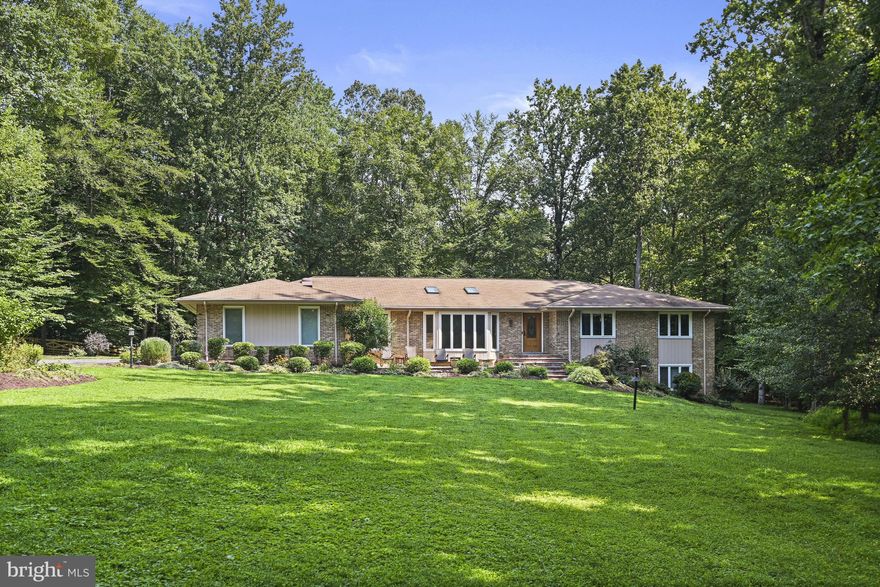 Experience effortless one-level living on a peaceful street surrounded by mature hardwoods and lush landscaping, with a sparkling pool as the stunning focal point. This beautifully maintained and thoughtfully upgraded contemporary residence is perfectly situated on 2 scenic acres, blending modern design with warmth and livability.

Expanded and enhanced throughout with custom features and high-end finishes, the home offers soaring vaulted ceilings, skylights, and abundant natural light streaming through walls of windows that seamlessly connect indoor and outdoor spaces. The open-concept layout is ideal for everyday living and entertaining, anchored by a chef-inspired kitchen with premium appliances, generous prep space, and stylish finishes—all flowing into the spacious family room.

Recent updates include the transformation of the main-level office into a true bedroom complete with a closet and a newly redesigned en-suite bath featuring dual access—expanding flexibility and functionality.

The walk-out lower level extends the living space with a full bathroom, bright bedroom, expansive recreation room, and abundant storage—ideal for long-term guests or multigenerational living, hobbies, or separate living quarters.

Outdoor living is just as impressive, with a large deck and patio overlooking the pool, a charming front courtyard, a detached shed, and a 3-car garage. Set on a gentle rise and surrounded by natural beauty, this tranquil retreat offers the best of private country living with easy access to modern conveniences.