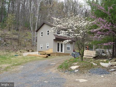 Enjoy all of what Mother Nature has to offer in private wooded setting w/plenty of wildlife. Property has a well yielding 80+ GPM. Home site on top of ridge has been cleared and has valid perc for sand mound. Two-story storage shed w/vinyl siding included. Zoning is Open Space.