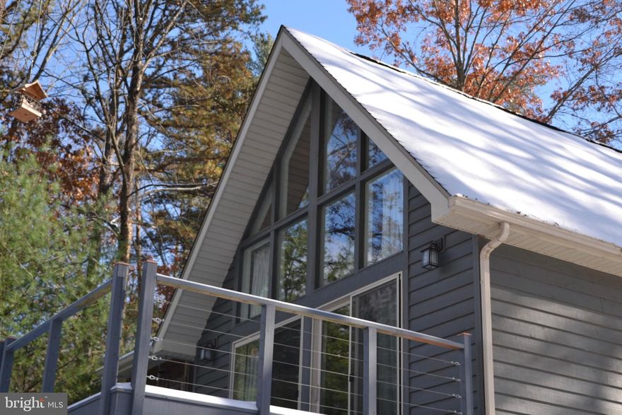 Charming A-Frame Cabin: Investment Opportunity or Personal Retreat! Discover your own romantic getaway with this beautifully renovated 1-bedroom, 1-bathroom A-frame cabin, complete with a spacious loft. Built in the 1980s and meticulously maintained, this charming home blends modern updates with timeless appeal, including High Speed Fiber Optic internet service. Currently thriving as a successful short-term rental, the property boasts a 4.99-star rating on Airbnb and stays consistently booked. Nestled in the serene wooded hillsides of the George Washington National Forest in Lost River, this cabin offers a peaceful, cozy retreat from city life. Inside, an open-plan kitchen and dining area flow effortlessly onto a large deck, ideal for relaxing with sunset views. An enclosed screen porch extends your seasonal living space, making it perfect for entertaining or quiet moments with nature. The primary bedroom features a queen bed and ensuite bathroom, while the loft offers a space for reading, watching movies, or accommodating additional guests. Set on 7.5 acres of forested hillside, this property provides ample space for exploration. Whether you're looking for a solid investment or a personal hideaway in the mountains, this cabin is a rare opportunity. Schedule your appointment today!