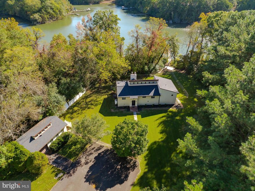 Waterfront living with deep water sitting on 1.23 acres and just around 167ft  of waterfront footage.  Ready to bring your sailboat and explore the tranquil waters on Saint Inigoes Creek with direct access to the St Mary's River and the Potomac River.  Enjoy crabbing, fishing, kayaking, boating or swimming right from your private pier.  Relax with your coffee or beverage of choice on the upper deck of the home watching the wildlife or sit by a fire on your future decks or patio.  

This spacious home features 3 bedrooms, plus a dedicated office that could easily be converted into a 4th bedroom.  The main level showcases vaulted wood-beamed ceilings, a bright open living area and dual fireplaces.  Large primary bedroom features double sliding doors onto the upper deck along with a unique en-suite that allows for a semi-private , yet shared-space with individual closets and sinks.  The lower level of this expansive home includes a large bedroom, full bathroom and two additional rooms ideal for a home gym, possible guest space, hobby space or second office.  You will also find a lower level kitchen/wet bar area,  and a cozy living  room complete with fireplace, perfect for multigenerational living or entertaining guests.   
BONUS Space includes  a detached garage unit with studio space where your imagination can run free.   Come make this your full-time retreat,  potential AirBNB or a second home to get away from the hustle and bustle of the day to day.  

Recent upgrades include New Roof (July 2025),  New interior doors, refrigerator, dishwasher (2024), HVAC-Heat pump with propane back-up for those chilly winters (2023), newer carpet and LVP. 
Home is centrally located to NAS Pax River, Webster Field, St. Mary's College and within 15 mins to shopping and amenities. Contact agent with any further questions.