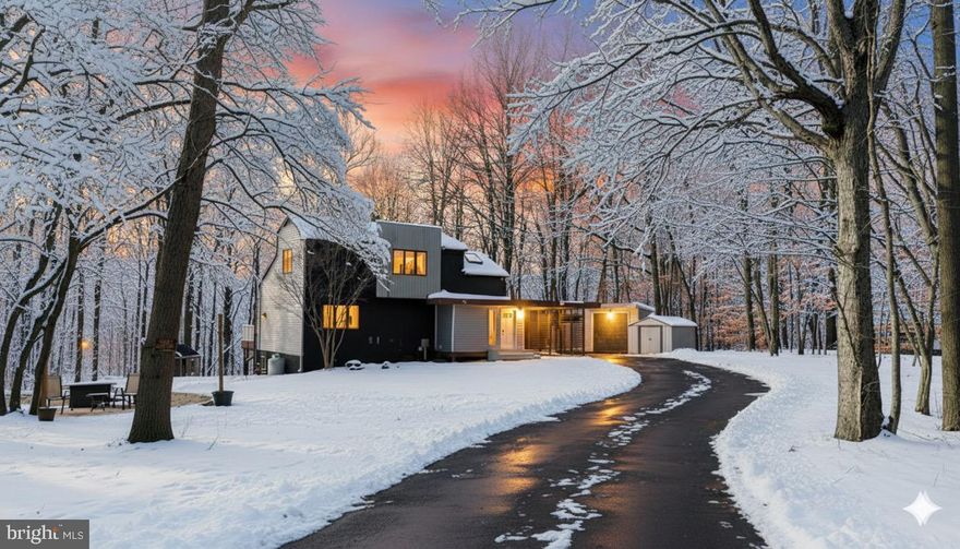 Tucked away on a private, wooded five acre setting, this striking contemporary home offers space, privacy, and a story that sets it apart. Known by many in the Chesapeake Beach area and throughout Northern Calvert County, the home gained recognition after a renovation featured on The Ellen Show. Since then, it has been thoughtfully updated again while off the market, with a focus on the improvements that matter most.
All major systems have been addressed. A BAT septic system with new drain fields was installed in 2021. The architectural shingle roof was fully replaced in 2022. A brand new electric HVAC system was installed in 2025, with the manufacturer warranty transferring to the new owner at closing. Beautifully refinished hardwood floors run throughout the main living spaces, giving the home a warm and polished feel.
The main level is open and filled with natural light. The eat in kitchen features vaulted ceilings, skylights, marble countertops, and Viking oven, making it both functional and visually striking. The living room centers around a propane fireplace with a built in mantle and shelving, creating a comfortable space for everyday living or entertaining. Sliding barn doors lead to the main level primary bedroom and private bath suite, offering convenience and separation from the rest of the home.
At the rear of the house, a spacious Trex deck overlooks the wooded landscape. Thoughtful landscaping, stone, and pavers below the deck enhance the setting and make it easy to enjoy quiet mornings or relaxed evenings outdoors.
The upper level includes two additional bedrooms and a full bath, ideal for guests or flexible use. The lower level is newly renovated. It already includes a third full bath, a recreation area, an additional room suitable for a possible fourth bedroom, and a rough in for a future wood burning stove.
The property itself is a standout. Covered parking, a paved driveway, two storage sheds, and even a treehouse are already in place. The treehouse conveys as is, with condition unknown. With five wooded acres, this property is well suited for nature lovers, those seeking privacy, or anyone wanting a true retreat without giving up convenience.
Despite the peaceful setting, the location offers easy access to local favorites like the farmers market, boardwalk, and well loved restaurants. Commuters will appreciate proximity to Joint Base Andrews,  Annapolis, Patuxent River, and Washington, D.C..
This is a home where the heavy lifting has already been done. The systems are in place, the setting is exceptional, and the next chapter is ready to be written.