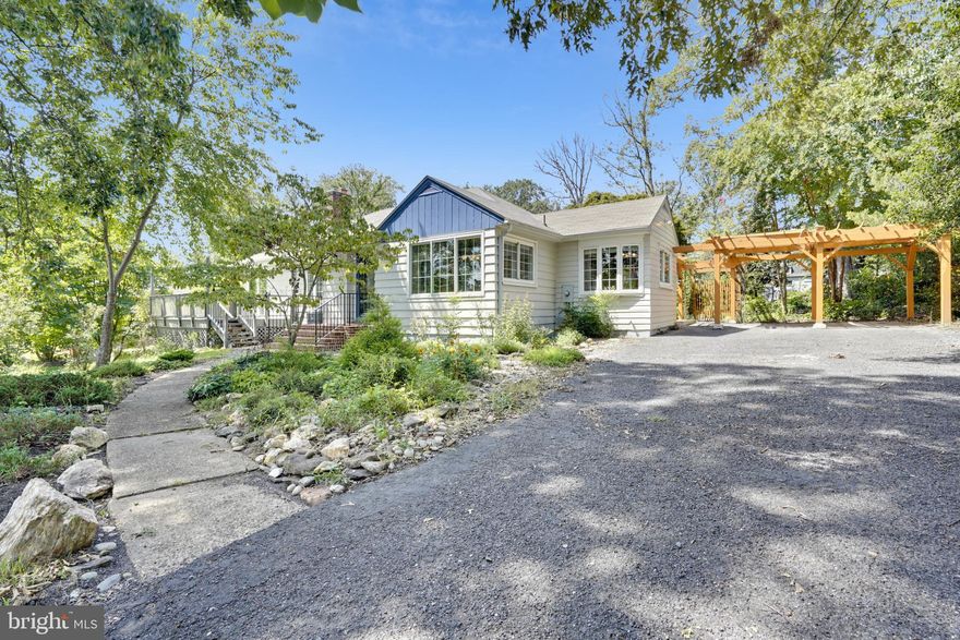 Charming "cottage style" rambler with great curb appeal situated on a large .63 acre lot and located in the highly sought-after Dunn Loring neighborhood! This wonderful home welcomes you with an inviting brick paver front porch, tiled entry foyer and newly refinished hardwood throughout. This home has a spacious sunlit living room with large windows and wonderful fireplace, a separate formal dining room with original built-ins, a den/office/family room leading out to an awesome front deck. Spacious updated kitchen with plenty of cabinetry, stainless steel appliances, granite countertops, and breakfast eat-in! The kitchen opens to an awesome slate patio with views of the superb backyard with multiple patio spaces and beautiful flower and vegetable gardens with slate and pebble walkway that wind through the lovely gardens to a stacked stone waterfall fountain with Koi pond. The main level boasts three bedrooms and two renovated bathrooms. Additional fourth bedroom and third full bathroom on lower level. Fully finished basement with recreation and billiard rooms, bonus/office room, laundry room, workshop and plenty of storage. Basement walkout to an amazing greenhouse and the backyard oasis...a gardeners' delight!  And, a large garden shed and a two car trellis carport. New roof 2019 and new AC 2020. This incredible location is just minutes from Tysons Mall, Tysons Galleria, Tysons and Dunn Loring Metros, grocery, shops, restaurants, parks, W&OD trail and all the major thoroughfares 495/Rt66/Rt7/Rt29/Rt50. A must see!