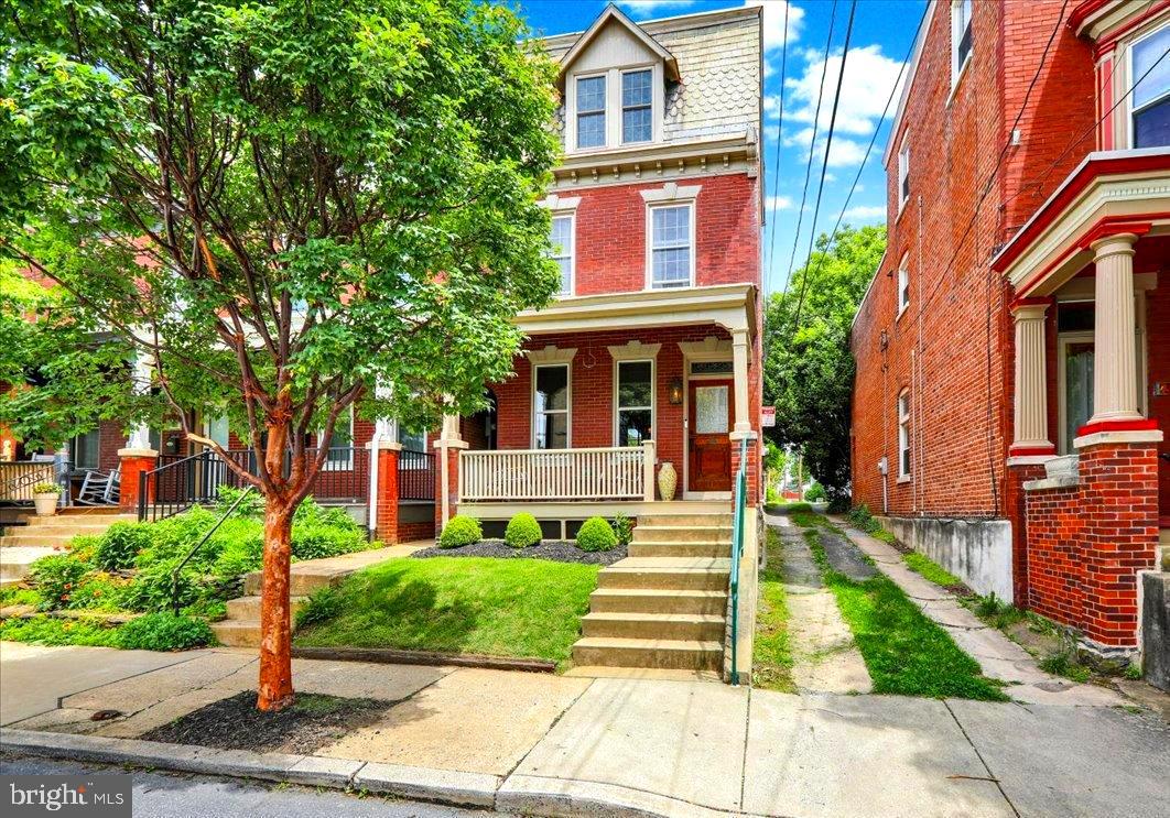 Nestled in the center of Lancaster's West End this turn of the last-century traditional brick property sits at the end of a row with a private alley running the length of the property. The inviting front porch is a summer evening's best friend. Inside, renovated oak floors grace the home with original woodwork, unscathed by time and paint. A modern kitchen and powder room bring the home to the 21st century. The formal living and dining room adjoin one another complete with period lighting. The carved oak staircase in perfect condition leads to two bedrooms and a small office or nursery. The second floor bath was remodeled with a Scandinavian blue and white tile combination. The third floor offers two more brightly decorated bedrooms. Wherever the owner has renovated this home it has been with the most careful eye.
All of the back windows have a view of the perfectly trimmed boxwood topiary, well manicured grass with attractive pavers and fencing. The path leads to the private parking beyond the gate.
There is a pre-listing inspection report available along with the recently completed repairs, including new central air and furnace systems installed in 2024, to give prospective buyers peace of mind. All appliances Included.
The location of this property cannot be exaggerated for its desirability. Schools and churches, shops and restaurants are all located within walking distance enhancing the Lancaster City Life experience.