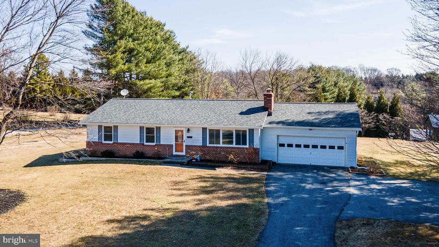 Welcome to this stunning rancher situated on over an acre of land with a spacious 2 car garage! Offering 3 bedrooms and 2 full bathrooms, this home features comfortable main-level living with thoughtful updates throughout.

Enter into the inviting living room showcasing recently updated laminate plank flooring that flows throughout the main level, along with all new Thompson Creek windows (2023). A charming brick-faced fireplace anchors the space and creates a cozy living space. The layout flows into the dining room and kitchen, creating an ideal setting for everyday living and entertaining.

The dining room includes a glass slider door leading to the rear yard, while the kitchen offers white cabinetry, stainless steel appliances, a new refrigerator and dishwasher (2021), and a brand-new induction stove (2025). The kitchen conveniently connects to the attached two-car garage, complete with a new garage door system (2023).

The main level includes a primary bedroom suite with a private full bathroom, along with two additional bedrooms and a second full bathroom. Bathrooms include one stall shower and one tub/shower combination, and all bedrooms feature ceiling fans.

The lower-level basement was recently finished in 2021 and adds valuable living space with a family room, bonus room, laundry room, and two storage rooms. The family room and bonus room feature luxury vinyl plank flooring and recessed lighting, and the bonus room includes an added closet, offering flexible use as a potential fourth bedroom, office, or playroom.

Outside, enjoy a large yard complete with a concrete pad (2023), two sheds, and play set, perfect for outdoor enjoyment. Additional upgrades include a new front door and storm door (2025), Class A fuel chimney lining with cap and storm collar (2020) and a water purification system (2021).

This move-in ready home combines functional living space, extensive updates, and a peaceful setting, don’t miss the opportunity to make it yours!