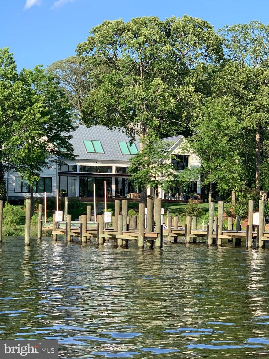 Stunning Modern Chic Farmhouse  ideally located on prestigious Melvin Road. Custom built by John Joy and Joy Custom Design Build. Artistry blended with the perfect waterfront setting. Exquisite details through out. Custom DaVinci 84"fireplace in family room with floor to ceiling stone. Creston Home automation system with touch screen control pads. Wolf top of line appliances.  Dazzling Cambria countertops thru out kitchen/bathrooms. Modern Custom stairs. Gorgeous 32' x 16'  waterfront heated pool with pebble tech finish/5' sunshield. Brazilian Ipe deckings and propane fire-pit with remote control start. Outdoor Kitchen with stainless steel cabinets, custom mahogany back & 36" Wolf gas grill.  Robust 128' dock with 70' & 48' fingers at an 8 MLW. Dock is covered in Trex transcend composite decking & includes (1) 8,000 lb boat lift,  (1) 10,000 lb boat lift, (2) jet-ski lifts, & one of of a kind integrated hammock. 3 car garage Custom hardscape and landscaping includes automated irrigation system & integrated landscaping lighting.