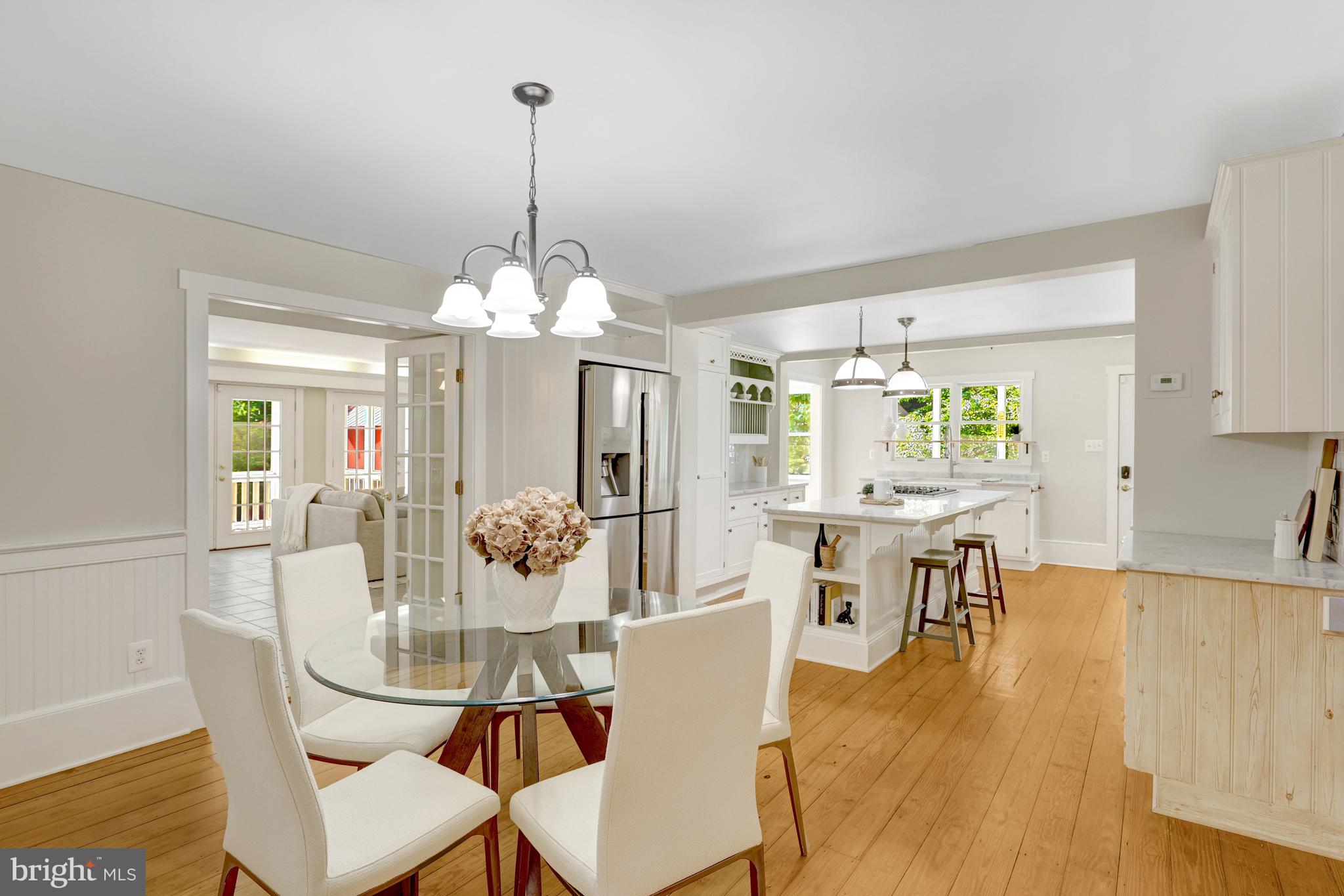 ***Open Houses Sat and Sun 8/23-24, 2-4pm***A Rare Gem in Historic Downtown Herndon – 1904 Charm Meets Modern Luxury
Homes like this don’t come up for sale often—this is your opportunity to own a truly special piece of Downtown Herndon history. Built in 1904 and lovingly expanded and updated over the years, this home blends timeless character with thoughtful modern amenities.
From the moment you arrive, the curb appeal delights—a classic white picket fence, vibrant organic gardens, and mature plantings including peonies, persimmon, blueberries, raspberries, apple and cherry trees. Every inch of the landscaping has been curated with care, offering a calming, nature-filled escape just blocks from the heart of town.
Step inside and be instantly drawn through the original home, the thoughtfully designed addition, and out into the lush backyard. The living room is bright and inviting, featuring original hardwood floors, elegant moldings, and French doors that open to a tranquil screened porch—just one of three incredible outdoor living spaces.
The dining room is ideal for entertaining, filled with sunlight and rich with period charm. And then there’s the kitchen: a chef’s dream! Fully renovated with marble countertops, premium stainless appliances, two oversized farmhouse sinks, and luxurious custom Smallbone cabinetry. The expansive island offers endless prep space and seating, and the adjoining breakfast nook is a wonderful spot for morning coffee.
A three-level addition, completed around 2000, brings even more space and flexibility. On the main level, you’ll find a stunning 31' x 13' family room with in-floor heating, a full bathroom, and potential for a main-level primary or guest suite. French doors lead to a serene flagstone patio shaded by an English rose-covered pergola—perfect for outdoor dining or a spot to peruse Instagram.
Head upstairs via your choice of two staircases, including a tucked-away set off the kitchen. The primary suite is spacious and serene, featuring garden views, ample closet space, and a spa-like bath with heated floors, a jetted tub, and a walk-in, door-free shower with multiple shower heads. An attached room—originally the primary bedroom—offers versatility- a quiet home office? Sitting room? A HUGE closet? or a 4th bedroom!
Two additional upstairs bedrooms also feature gorgeous original hardwood floors and share a third full bathroom in the hall.
Need space for hobbies, work, or adventure? The large barn was originally built to house an RV! The workshop was originally a 2 car garage... both spaces offer exceptional flexibility. Whether you’re into woodworking, art, or just need a space to retreat and enjoy the sound of rain on the metal roof, you’ll love it here.
All of this, just blocks from Herndon’s vibrant downtown: restaurants, shops, Herndon Library, Dairy Queen, Great Harvest Bread, Friday Night Live summer concerts, Tuesday concerts at the old Town Hall, a farmers market on Thursdays, W&OD trail, Wintermarkt and more! Enjoy easy access to the Metro Silver Line- three stops are nearby, Dulles Airport, Reston Town Center, and miles of nearby parks and trails.
With Town of Herndon services including trash pickup, recycling, snow and leaf removal, and community police and public works—you’ll feel completely spoiled living here.
This is more than a home. It’s a lifestyle. Welcome to Downtown Herndon. Welcome home.