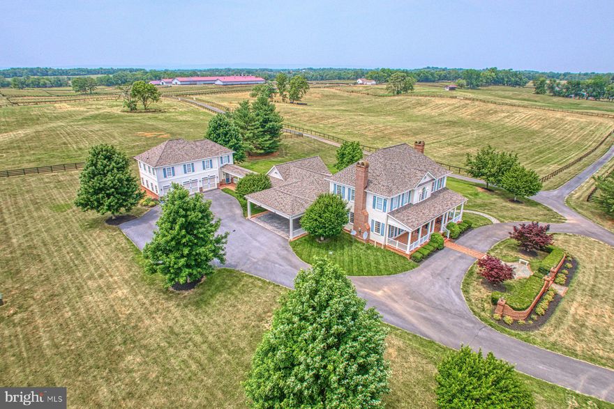 Welcome to Shotwell Farm, a 172-acre equestrian estate and recognized Jefferson County landmark. A tree-lined drive leads to a Southern Living style main home with a detached garage and 2-bedroom apartment. A circular drive serves the residence, while a separate entrance directs visitors to the equestrian facilities.
The main barn spans 37,857 square feet and features a center-stall layout, generator, reception area, two offices, laundry, and three staff apartments (one on the first floor, two above). Beyond reception are 29 stalls, a wash stall, and a 80' x 300' indoor arena at the core of the barn.
Nearby, a 12,000-square-foot building includes a dedicated breeding area and a 2,520-square-foot maintenance shop with 200-amp service and water. An additional 39 stalls bring the total to 68. Two 6,000-square-foot structures at the rear provide hay and equipment storage; the hay barn includes a 16' x 100' lean-to.
Pastures are enclosed by 18,000 linear feet of four-rail blackboard fencing and 7,500 feet of top-rail fencing with diamond wire. The farm is well-equipped with run-in sheds, ample storage, and 29 automatic waterers.
Also on the property is a 1,200-square-foot split-level manager’s home with 3 bedrooms, 2 baths and an attached 2-car garage.
Beautiful rolling pastured, convenient  to both Charles Town racetrack and Virginia.