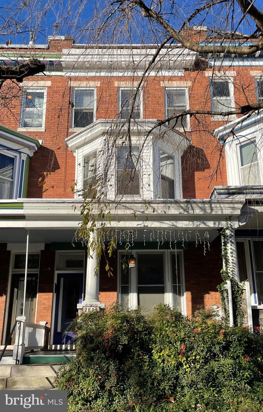 Circa 1912 this 5 bedroom, 3.5 bath Charles Village porchfront townhouse offers an abundance of charm with original details: mantels, wood floors, transoms, leaded/stained glass,  bay window clawfoot tub, built-in wardrobes, and tin ceiling & original cupboard in kitchen. Private porch off 2nd floor rear bedroom. Expansive rear deck with custom European retractable awning. Parking pad structure perfect for multi-use bonus space. Walk-in tile shower bathroom on lower level offers potential for basement guest suite. Lovingly owned & continuously maintained by just two families since construction. New main upper, lower and front porch roofs (October 2022). Two porches and a deck with an intimate garden. Convenient to Penn Station, Waverly Farmers Market, Baltimore Museum of Art, JHU Homewood campus, Union Memorial Hospital, the Hopkins Shuttle, Wyman Park Dell, Motzi Bread, shopping and restaurants. Eligible for $14,500 Johns Hopkins University LNYW grant. Property subject to CVCBD surtax FY2023 = $273.37.