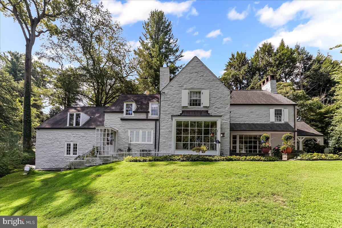 Elegant French Country Stone Home in Coveted Northside Bryn Mawr
Nestled on nearly an acre of lush, park-like grounds, this French Country–style stone residence blends timeless charm with modern comfort. Located on a quiet stretch of Old Gulph Road, yet just minutes from Bryn Mawr’s vibrant shops, restaurants, and train station, the home offers both privacy and convenience.
Inside, the foyer opens to a sun-filled living room with a wood-burning fireplace, bay window, built-in shelving, and random-width hardwood floors. French doors lead to a serene flagstone patio. The formal dining room, also with a bay window and patio access, is perfect for entertaining, while the den features custom bookshelves and a wet bar. The spacious eat-in kitchen boasts granite countertops, stainless steel appliances, a built-in refrigerator, and abundant cabinetry. A powder room completes the main level.
Upstairs, the expansive primary suite offers two full bathrooms (one with heated floors) and generous closet space. Four additional bedrooms—each with direct bathroom access—including a private guest/in-law/au pair suite with sitting area and full bath.
The finished lower level provides a large family room, a fifth full bath, a laundry area, and substantial storage or hobby space. Outdoors, enjoy landscaped gardens, open and covered patios, and a two-car attached garage.
This exceptional property combines space, character, and a premier location—an opportunity to own a gracious home in one of Bryn Mawr’s most sought-after neighborhoods.