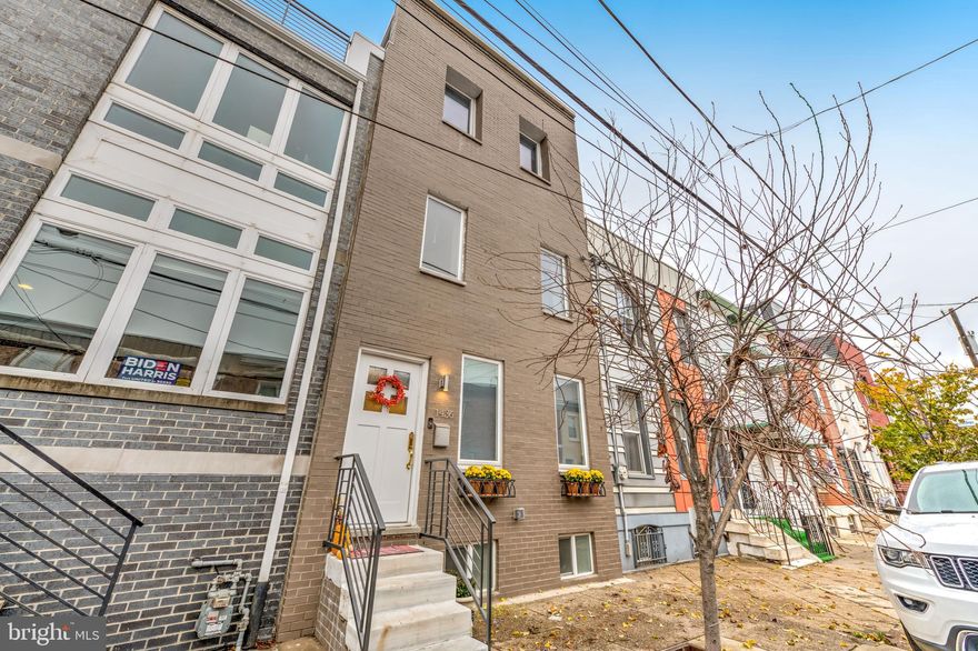 This stunning 3 bedroom, 3.5 bath, roughly 2500 sqft home, with a finished third floor, rooftop deck, yard and finished basement is located in close proximity to shopping, restaurants, entertainment, transportation and hospitals. Upon entry, you will be wowed with  a wide open living room and dining room, finished with crown molding, half wall wainscoting, contemporary wood flooring and a chandelier in the dining area. Continue on to a stunning upgraded kitchen, boasting quartz countertops, stainless steel appliances, contemporary high gloss cabinetry, glass tile backsplash and a bar counter with sink and pendant lighting. A sliding glass door leads will lead you outside to your own rear yard, approx 15 ft. For convenience, there is a powder room on the main level. Heading upstairs to the  second floor starts with a bedroom suite that offers two windows, double closet and a full marble tile bathroom with contemporary vanity. The sizeable rear bedroom offers a large triple window and double closet. Off the hall is a full tile bath with stall shower. On the third floor you'll find a spacious main bedroom suite, with two east facing windows, a walk-in closet and a luxurious marble tile bathroom with oversized stall shower with jet spray, elegant soaking tub, contemporary dual vanity, a watershed and closet. Steps lead up to a penthouse area with door leading out to over-sized rooftop terrace, with electric, water and lighting. Enjoy the stunning skyline views from sunrise to sunset! The beautifully finished basement makes the perfect den or family room, while also offering a rear mechanical/laundry room.  Seller is offering a One Year America's Preferred Home Warranty.