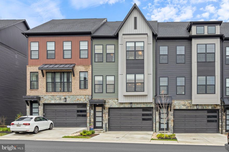 Bright & Beautiful 4BR/4.5BA Home with Stunning Views, Thoughtful Upgrades & Resort-Style Living.

Welcome home to this rare gem—a beautifully designed 4-bedroom, 4.5-bathroom retreat offering over 2,800 sq. ft. of thoughtfully crafted living space. Nestled in a prime location with unobstructed front and rear views, this home backs to a peaceful tree line, giving you the perfect blend of privacy and natural beauty. With perfectly situated east/west facing windows, natural light is yours all day long.

From the moment you step inside, you’ll be greeted by abundant natural light pouring through expansive windows, creating a warm and airy atmosphere. The open-concept living and dining area is both stylish and functional, featuring custom-built cabinetry that seamlessly flows into a dream kitchen. Here, you’ll find quartz countertops and backsplash, an oversized island, a custom range hood, premium Energy Star-rated stainless steel appliances, and a full dry bar with double pantry storage—ideal for both everyday living and entertaining.

Every inch of this home has been designed with comfort, style, and efficiency in mind. High-efficiency HVAC, luxury vinyl plank (LVP) flooring, and designer interior paint ensure a comfortable and low-maintenance lifestyle. Custom light-filtering and blackout window treatments provide privacy while maximizing natural light. The fully finished two-car garage adds convenience, while the custom fourth-floor loft serves as the perfect guest suite, home office, or private retreat with its own full bath.

Step outside and enjoy a feature no other home on the row has: a covered deck that transforms your back patio into a serene, all-weather retreat. Whether you’re sipping morning coffee, unwinding in the evening, or hosting friends, this space offers the perfect backdrop of peaceful greenery.

Beyond the home itself, you’ll love being part of the vibrant Watershed community, where resort-style amenities elevate everyday living. Enjoy access to a clubhouse, gym, fitness center, swimming pool, dog parks, walking trails, playgrounds, picnic areas, and lush green spaces—all just steps from your door.

Besides amenities in the Watershed community, you'll have easy access to major highways for effortless commuting, quick access to BWI Airport, NSA, and Fort Meade. Plus fun and shopping are minutes away with Arundel Mill Mall and Maryland Live! Casino just down the street.

Watershed offers the perfect balance of convenience, community, and nature—providing a lifestyle that’s as vibrant as it is peaceful. Don’t miss your chance to make this exceptional home yours—schedule a showing today!