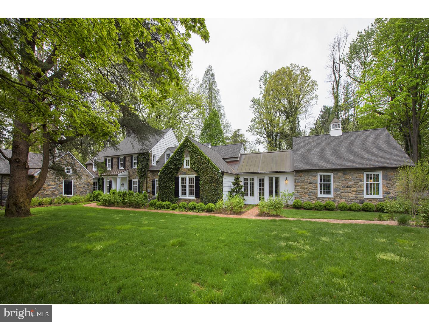 Welcome to 921 Mount Pleasant Road in Bryn Mawr. This move-in ready, newly renovated home has 5 bedrooms, 4.2 bathrooms, over 4,900 square feet on a gorgeous 1.52 acre lot. You are immediately drawn into the house down the brick walkway to the open concept foyer, living and dining room. This is the perfect setting for entertaining friends and family. The dining room, which can seat gatherings both large and small, includes beautiful wide plank hardwood floors, chair railing and overlooks the front lawn. The living room includes a wood burning fireplace with ornate mantle, built-in wall units, wide plank wood floors and access to the rear patio. The fabulous eat-in kitchen is a chef's dream. The kitchen includes an oversized granite island that can fit up to 6 bar stools, top of the line appliances, double ovens, Wolf range, tons of cabinet and counter space, 2 pantry closets and a breakfast room. The breakfast room includes a wet bar with beverage fridge, built-in work space and bench. A family room off the kitchen includes high ceilings, hardwood floors and overlooks the front yard. The first floor master retreat is an elegant space to unwind after a busy day. Enter the master suite through a wood paneled sitting area/office with wood burning fireplace, built-in wall unit, brick floors and access to the rear yard. The master bedroom has tons of natural light, high ceilings, a large walk in closet and a spectacular master bath that includes his and her vanities, a soaking tub, glass enclosed shower, high ceilings and marble flooring. A powder room, mud room, and access to the over-sized 3-car garage complete the first floor. The second floor includes 4 sizeable bedrooms, 2 with en-suite bathrooms, a full hall bath and a laundry room with sink and counter space. The finished lower level is the perfect space for a playroom or second family room with hardwood floors, full wet bar and tons of storage. The lush backyard includes an enormous stone patio and a second covered brick patio. Easy access to 476, 76 and Center City all while in the award winning Lower Merion School District!