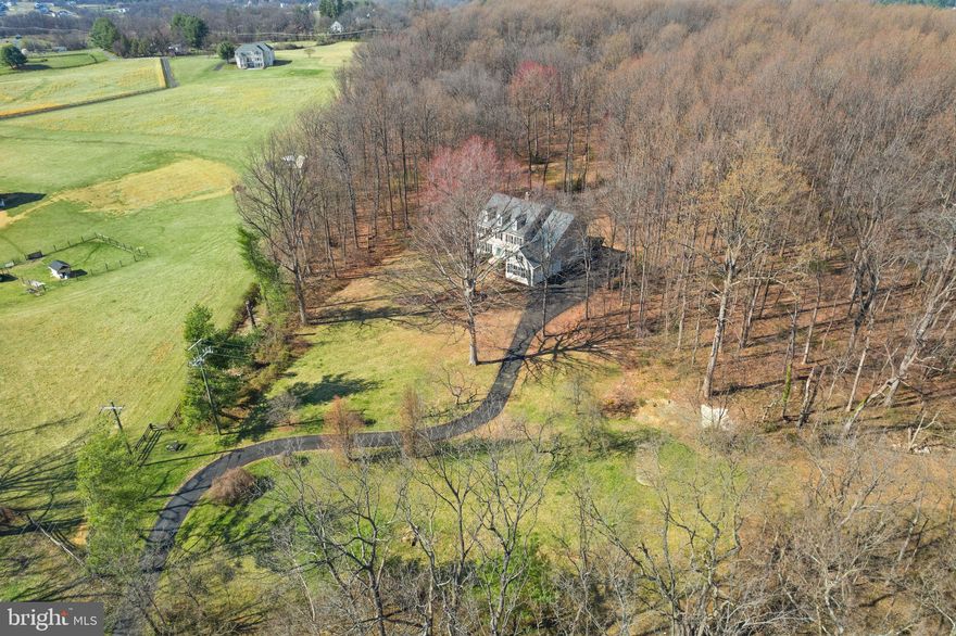 CHARMING COLONIAL HOME ON 11 ACRES! Welcome to this wonderful and well-maintained home, nestled on 11 private acres of open and wooded land in the heart of Western Loudoun County. Offering a perfect blend of seclusion and convenience, this property features no HOA (Zoned AR1), providing peace of mind and privacy. Despite its tranquility, you're just minutes from Route 7, local shopping, wineries, and breweries, offering easy access to everything you need. ** The home’s charming curb appeal, with low-maintenance vinyl siding and black shutters, welcomes you and your family! Inside, a grand two-story foyer with 10-foot ceilings creates a bright, open atmosphere from the moment you enter. Entertain in the spacious formal living and dining rooms, bathed in natural light. The main level also includes an office, ideal for remote work or study, and a well appointed family room featuring a wood-burning fireplace framed by stone, perfect for cozy evenings. The kitchen is a chef’s dream, with ample cabinetry and equipped with a  GE Monogram 48" built-in refrigerator, double ovens, granite countertops, a large island, and a pantry, offering ample space for cooking and entertaining. The breakfast area provides lovely views of the surrounding woods. A powder room, a convenient dog shower in the laundry room, along with a washer and dryer that convey, adds a practical touch to the home as well as a 3-car side entry garage. ** Upstairs, you'll find four spacious bedrooms, including the luxurious primary suite, a true retreat. The suite features a sitting room, spacious bedroom with tray ceiling and open views, two walk-in closets, and a spa-like bathroom with a large shower and a separate tub. Two additional bedrooms share a full bath, while a fourth bedroom offers its own private bath, providing flexibility and comfort for family or guests. The walk-up lower level is designed for both relaxation and entertainment. The large recreation room, with a wood stove, offers a cozy atmosphere. A wet bar, complete with a mini beverage cooler and dishwasher, makes hosting easy. Additional spaces include a bonus room and an exercise room, providing versatility for work, play, or relaxation. Outside, the property is a nature lover’s paradise. With easy access to the W&OD Trail, you can enjoy hiking or biking right from your door. The stone patio and nearby firepit create a peaceful outdoor retreat, surrounded by the beauty of the woods and the sounds of the local wildlife, including birds, and deer.  This home is equipped with a humidifier, dehumidifier, water softener, and a historic root cellar (as is), adding both comfort and character to the property. Updated HVAC systems and a new roof (replaced in 2023) ensure long-term efficiency and peace of mind. The entire home has just been painted on the interior and exterior and it's move in ready! This exceptional property offers the perfect balance of privacy, comfort, and access to nature, all while being just minutes from local conveniences. It’s a rare opportunity to own a home in one of Loudoun County’s most desirable locations.