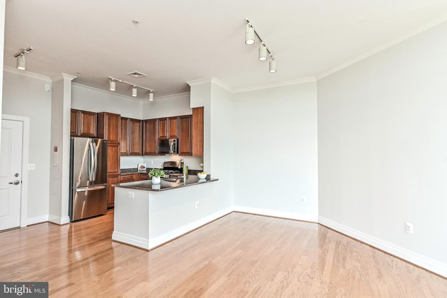 Open House Sunday, June 25th 2-4 pm. Absolutely stunning 1 bedroom Penthouse unit at the Elan at East Market Commons. Sun pours through the windows of this spacious home and highlights the gleaming hardwood floors throughout the unit. Gourmet kitchen features a granite counters, newer stainless steel appliances and an over sized island that can easily accommodate seating. The open floor plan effortlessly flows from the kitchen into the inviting living room and cozy balcony.  Master bedroom boasts a large walk in closet, access to the balcony and en-suite master bathroom with soaking tub. Your new home has a secure garage parking space and storage unit in addition to an on site fitness center, outdoor pool, pickle ball court, party room and a business center. Conveniently located across from Whole Foods and multiple dining and shopping choices and just a mile away from Fair Oaks Mall and Fair Lakes Shopping Center. You can't beat this location with a shuttle bus to the metro and only minutes away from I-66, Dulles Access Rd, Fairfax County Parkway, Route 50 & Route 29. Recent updates include: HVAC & kitchen appliances and the unit was just freshly painted for you. Welcome Home! Agents; Please see Agent remarks section. TY