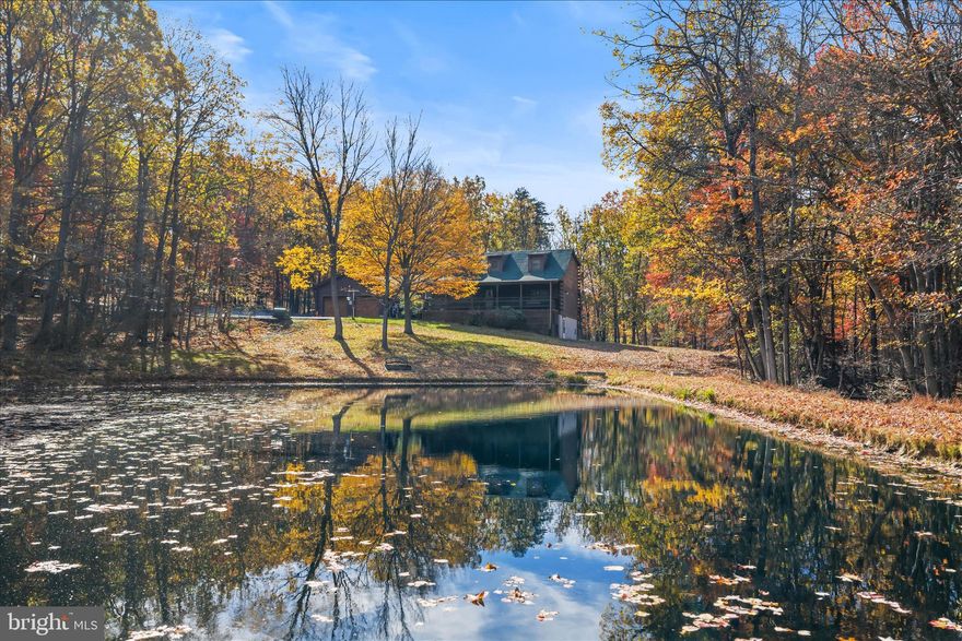 Remarkable home on 11.57 acres with no HOA.  Log home with beautiful wood interior.  Large kitchen and good sized rooms.  Nature lovers will love the pond and surrounding woods.  A bathroom on each level and covered front and back porches are also nice details.  The home features a detached garage, attached garage, and a storage building.  RV hookups are also on the property.  There is a separate room for a den or office.  Come book your appointment today.